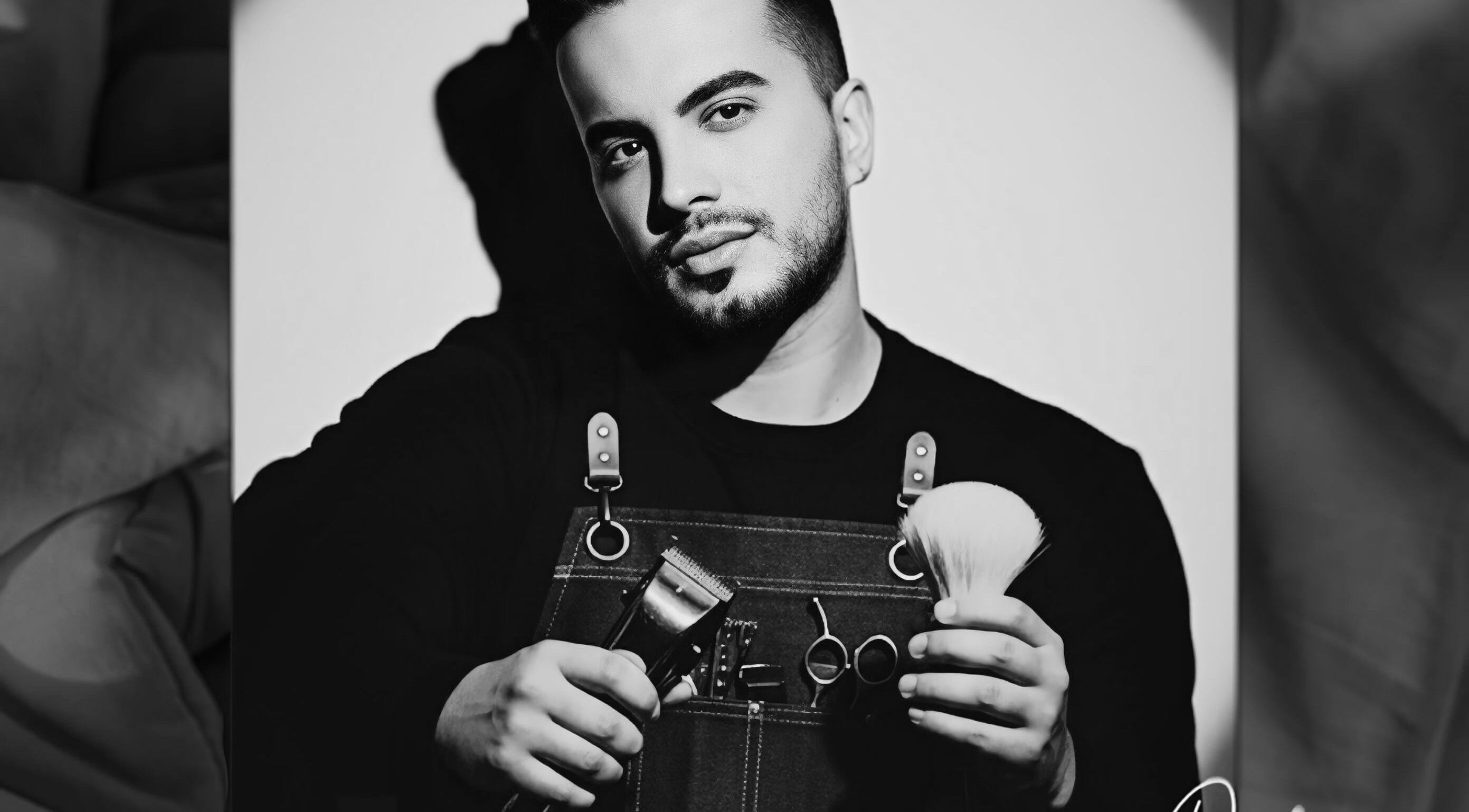 Barber at De Biasio Hair holding tools in Church, England, GB.