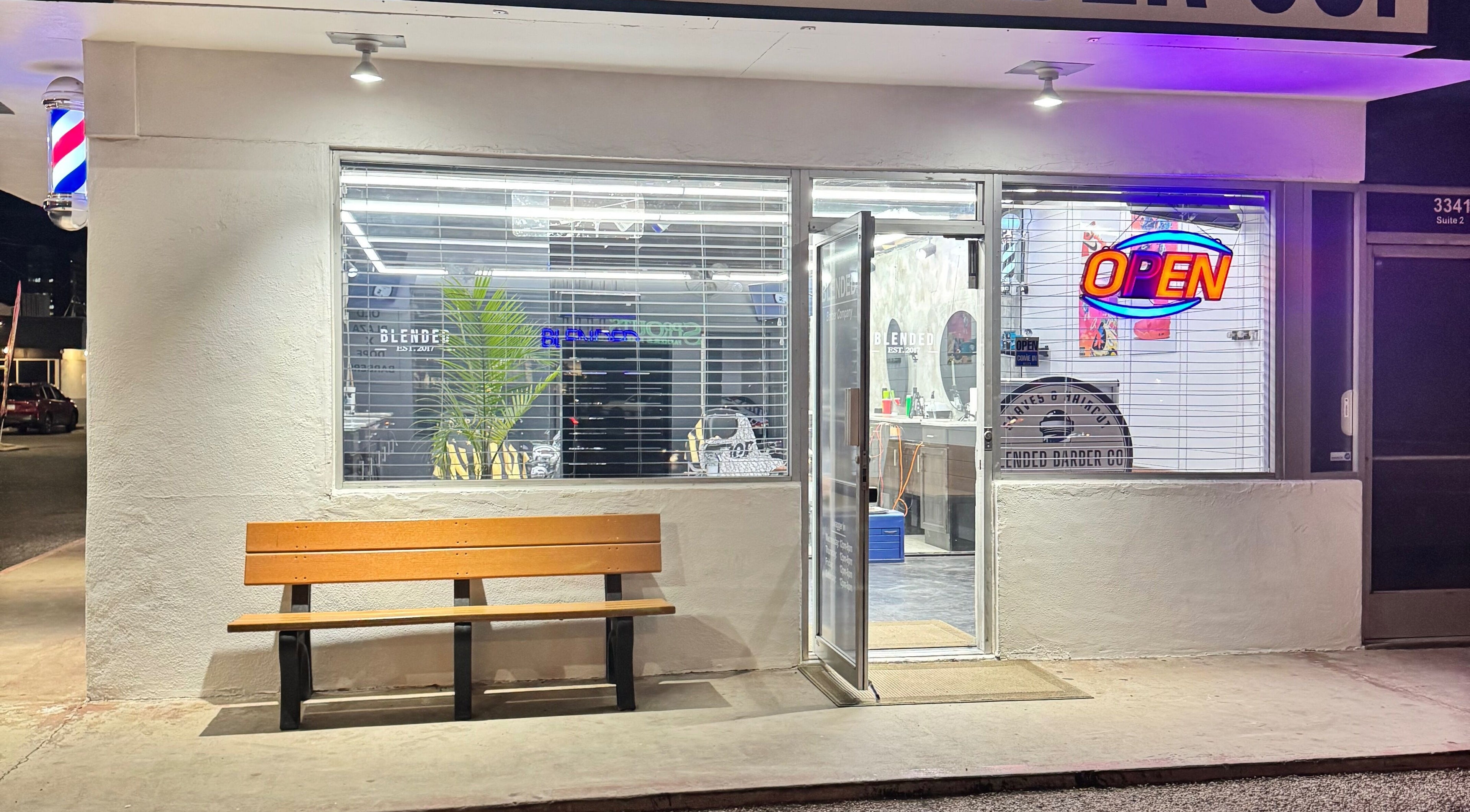 Rudy the Barber's inviting entrance in Phoenix, Arizona, US with a bright open sign.