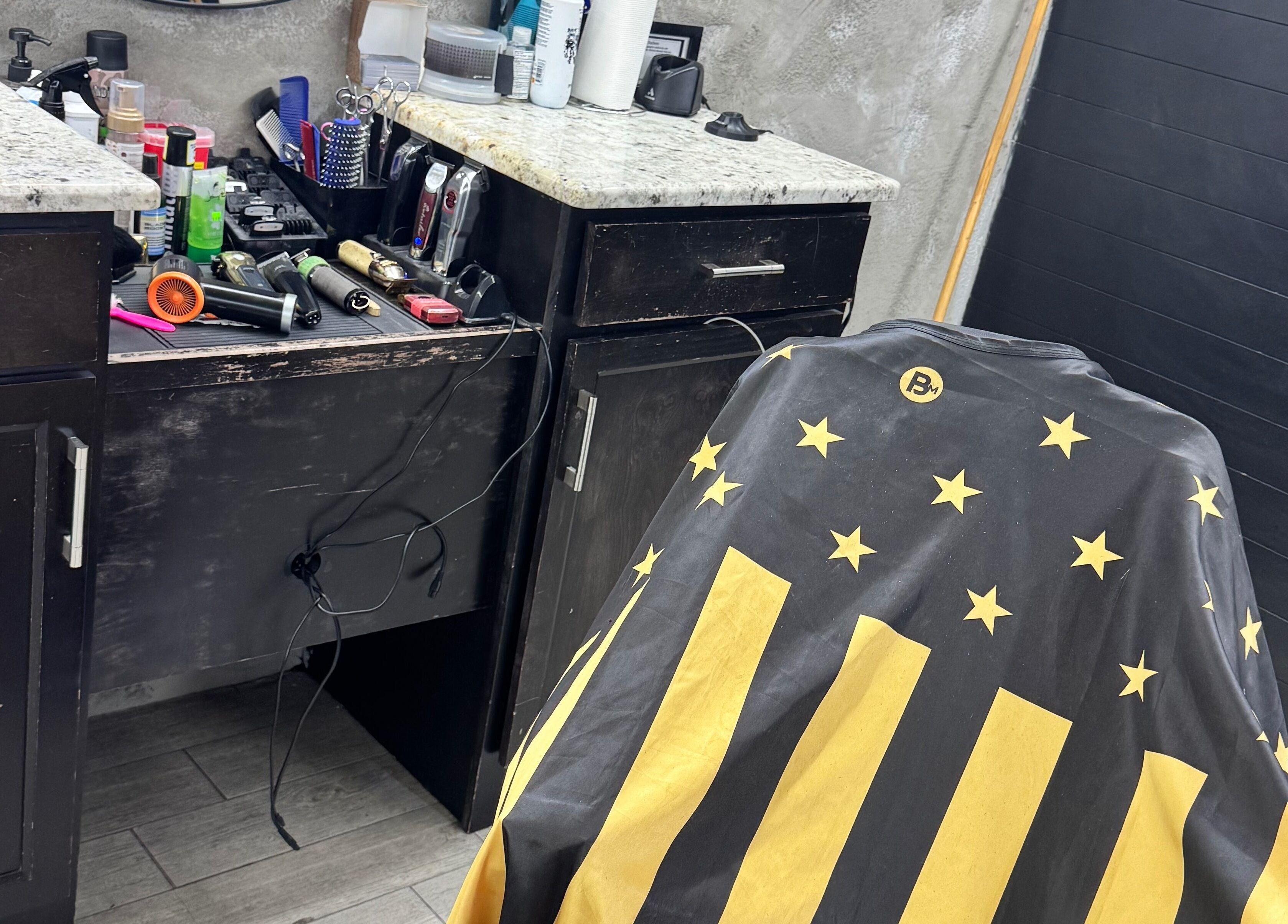 Barber station at Rudy the Barber, Phoenix, Arizona, US, featuring tools and a starry barber cape.