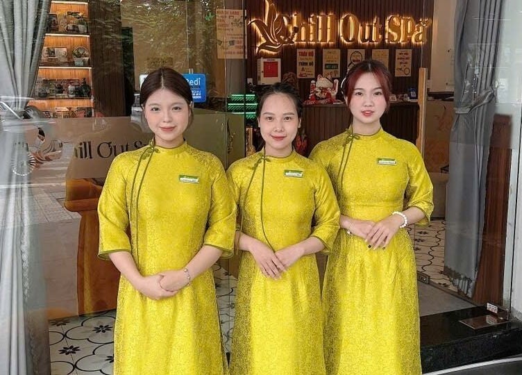 Staff in yellow attire greet guests at Chill Out Spa & Massage - 60 Do Ba, Ngu Hanh Son, Da Nang, Viet Nam.