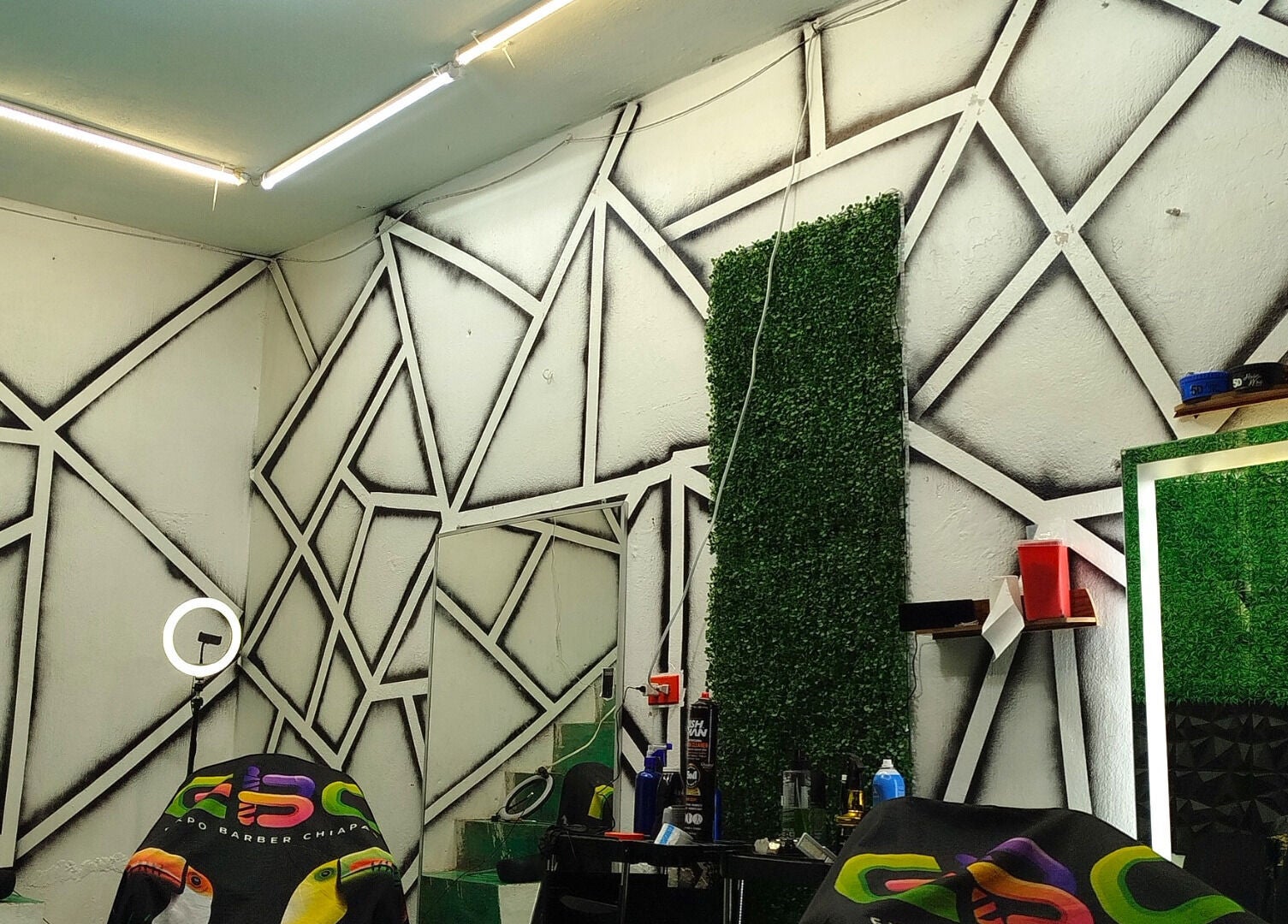 Interior moderno de Barbería Joss en Ocosingo, Chiapas, MX con paredes de diseño geométrico.