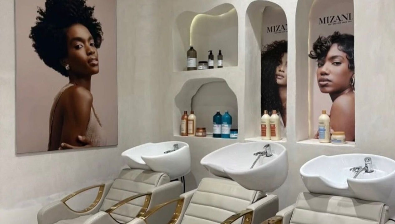 Stylish wash station at The Penthouse Beauty Studio, Sandton, Gauteng, ZA featuring modern salon chairs and products.