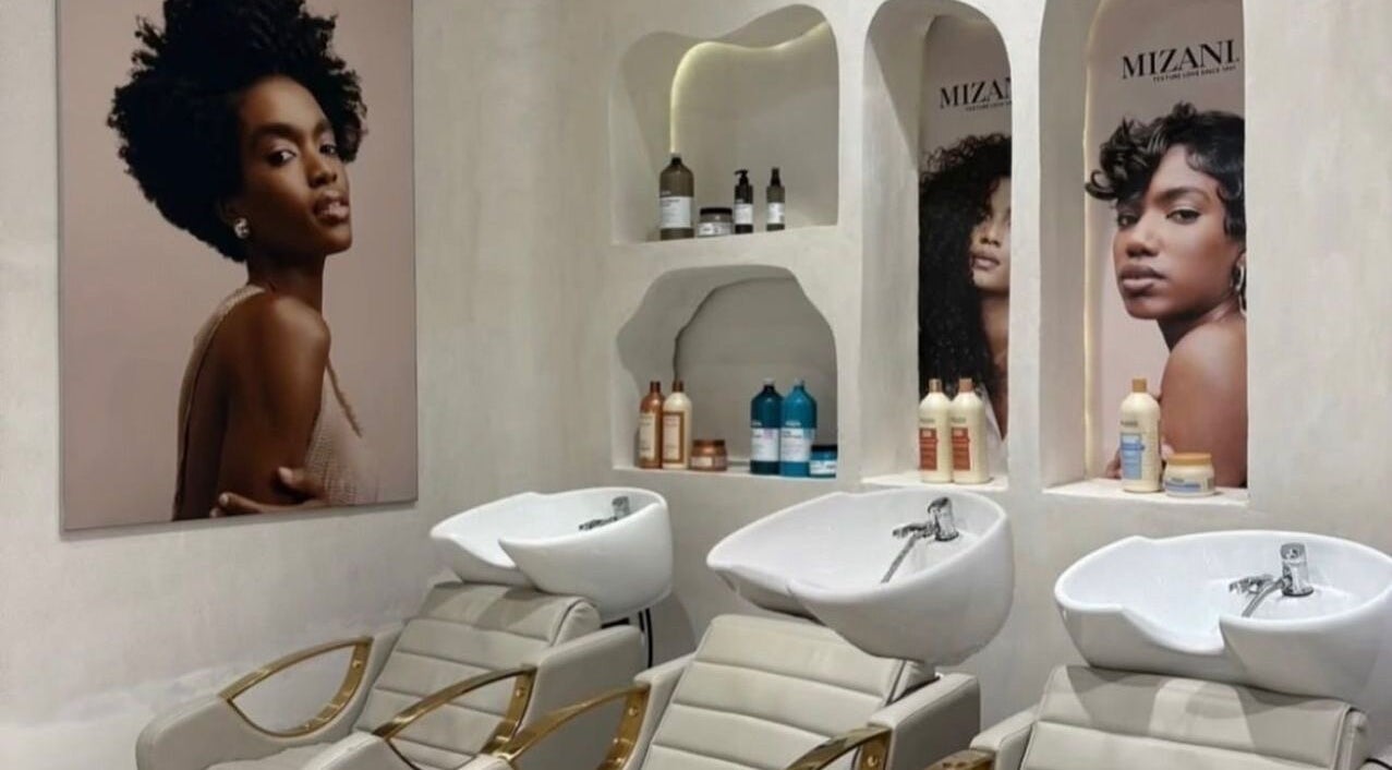 Stylish wash station at The Penthouse Beauty Studio, Sandton, Gauteng, ZA featuring modern salon chairs and products.
