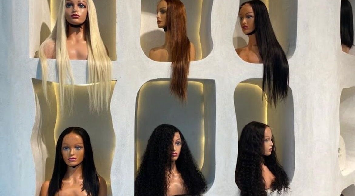 Mannequin heads with varied wigs at The Penthouse Beauty Studio, Sandton, Gauteng, ZA.