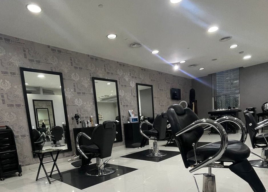 Modern salon interior at The Hair Alchemist, Dubai, Dubai, AE with styling chairs and mirrors.
