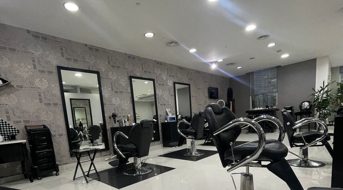 Modern salon interior at The Hair Alchemist, Dubai, Dubai, AE with styling chairs and mirrors.