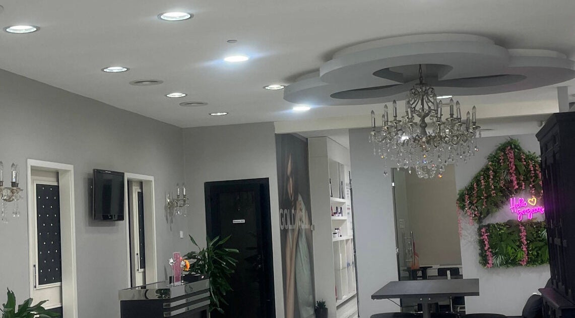 Chic interior of The Hair Alchemist in Dubai, Dubai, AE with chandeliers and modern decor.