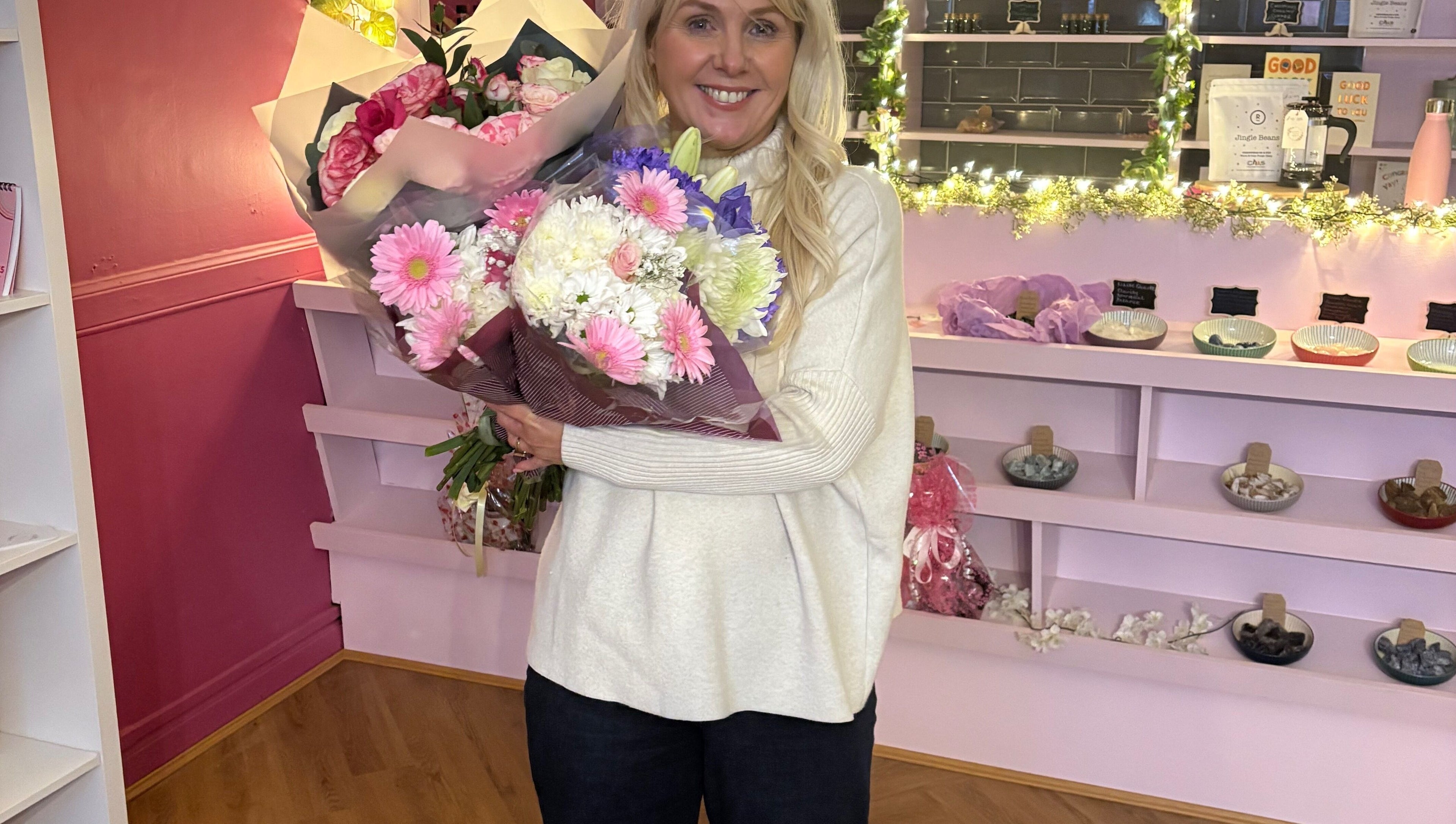 Woman holding bouquet at Beautiful Natural Spiritual, East Kilbride, Scotland, GB floral-themed interior.