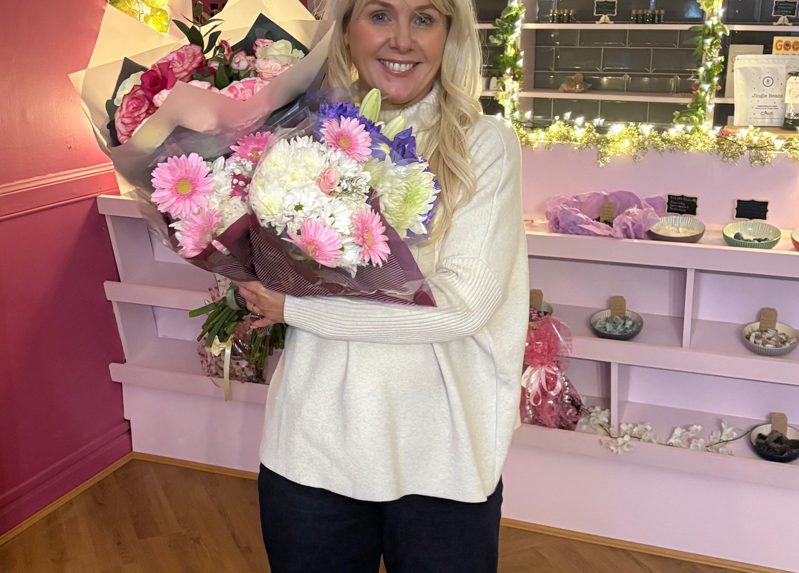 Woman holding bouquet at Beautiful Natural Spiritual, East Kilbride, Scotland, GB floral-themed interior.