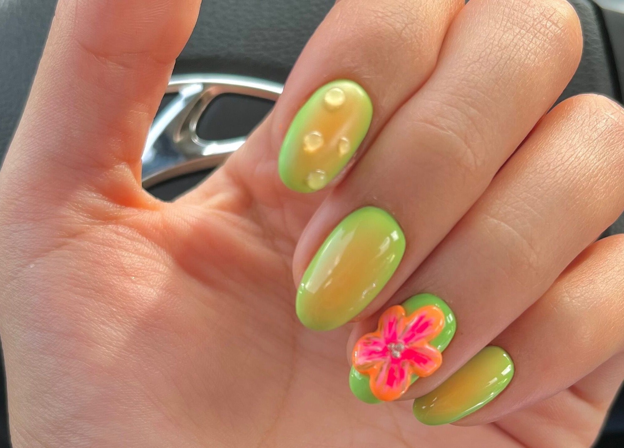 Vibrant tropical nail art at Nailz in Guaynabo, PR, PR, featuring green and orange hues with a flower design.