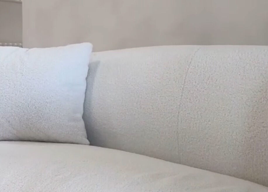 Plush white sofa with pillow in serene setting at Facemuse, Derby, England, GB.