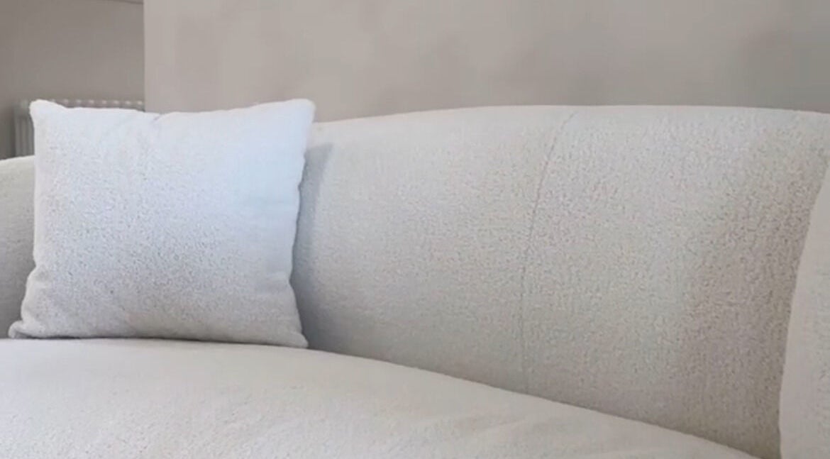 Plush white sofa with pillow in serene setting at Facemuse, Derby, England, GB.