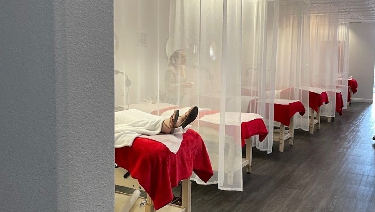 LashesByYuna spa room with red-draped beds in Henderson, Nevada, US providing a relaxing experience.