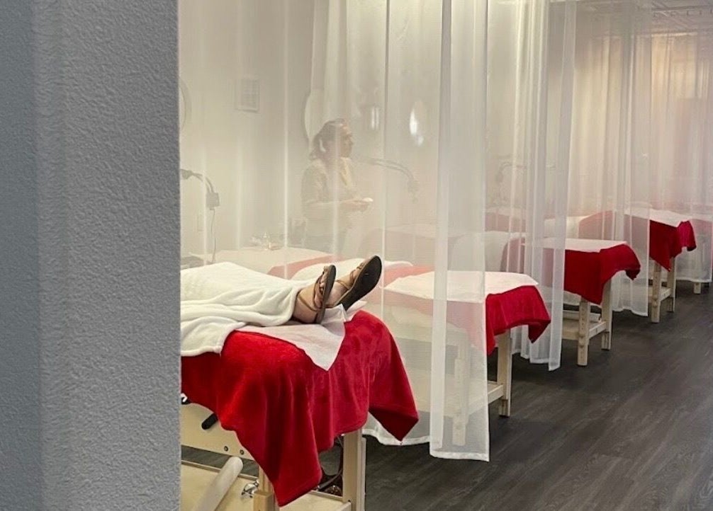LashesByYuna spa room with red-draped beds in Henderson, Nevada, US providing a relaxing experience.