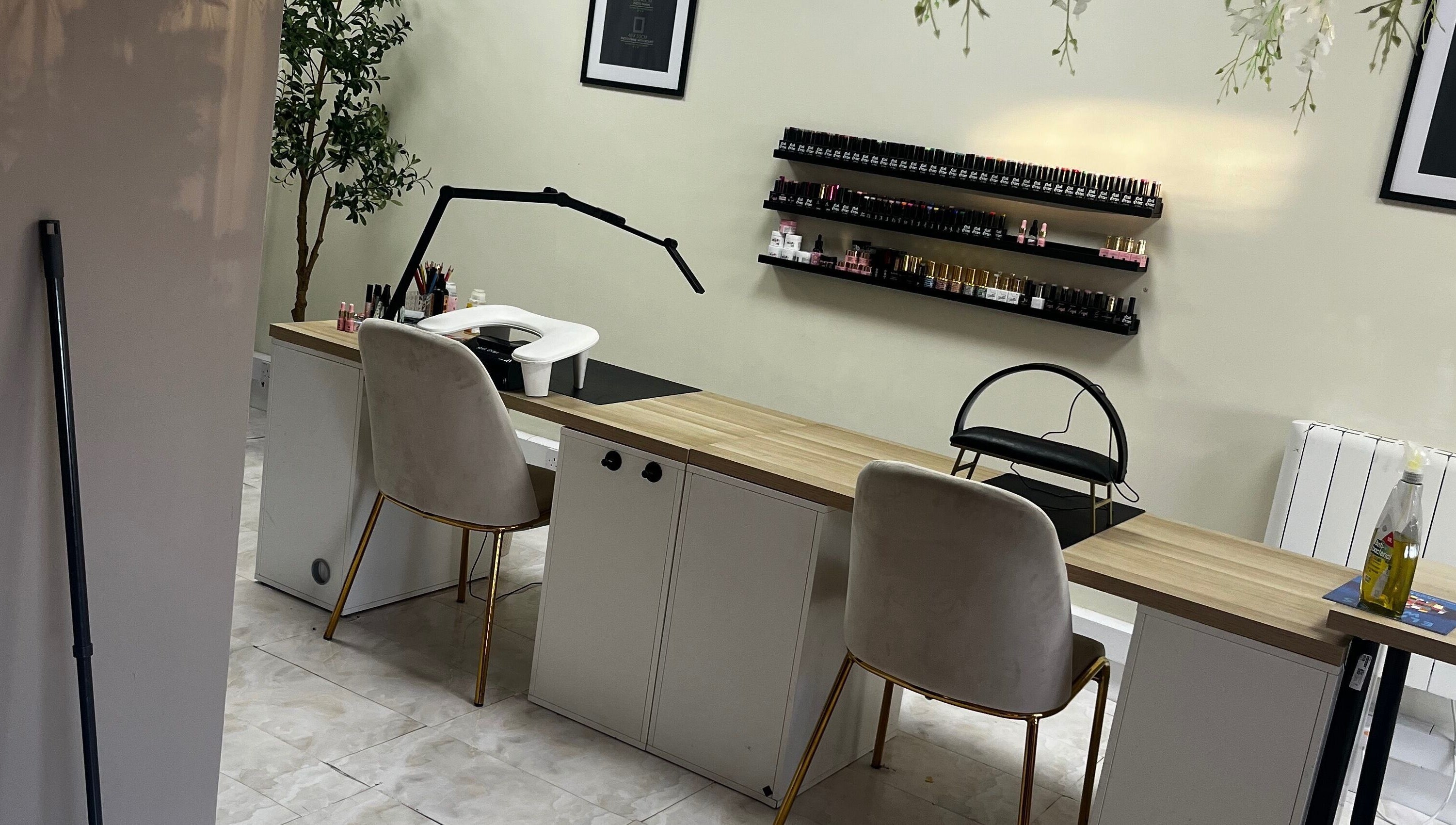 Elegant nail care setup at By Carly, Wolverhampton, England, GB with chairs and polish display.