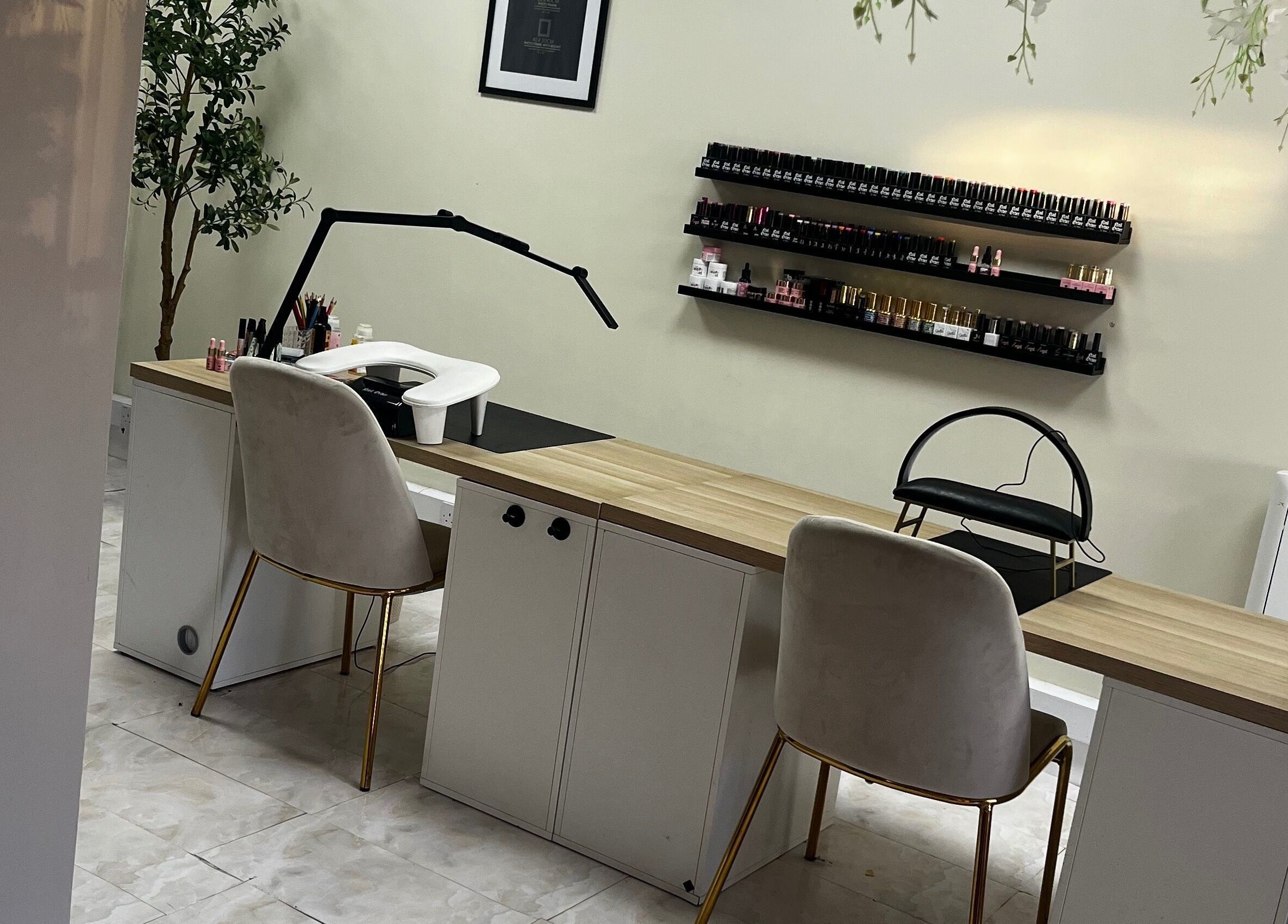 Elegant nail care setup at By Carly, Wolverhampton, England, GB with chairs and polish display.