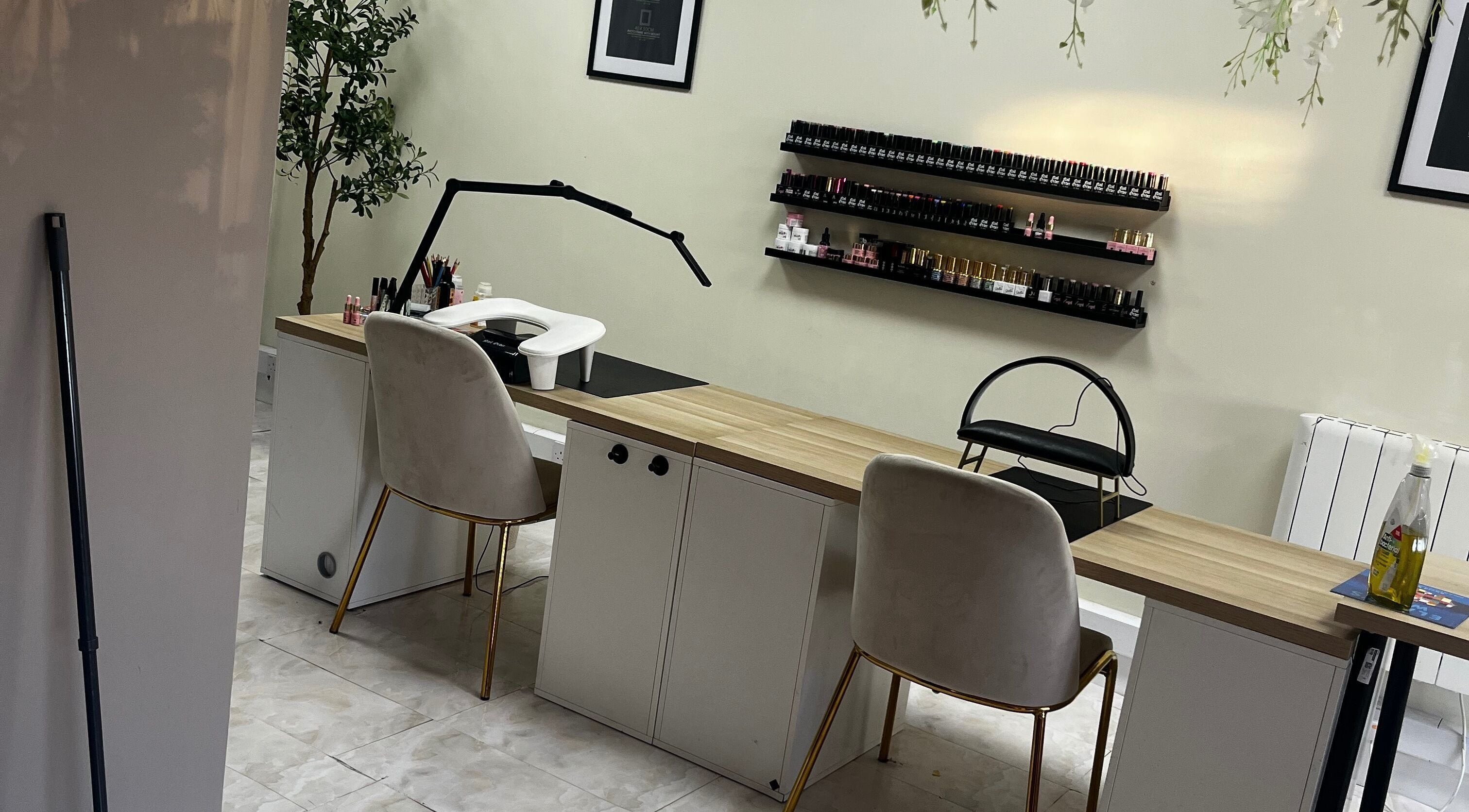 Elegant nail care setup at By Carly, Wolverhampton, England, GB with chairs and polish display.