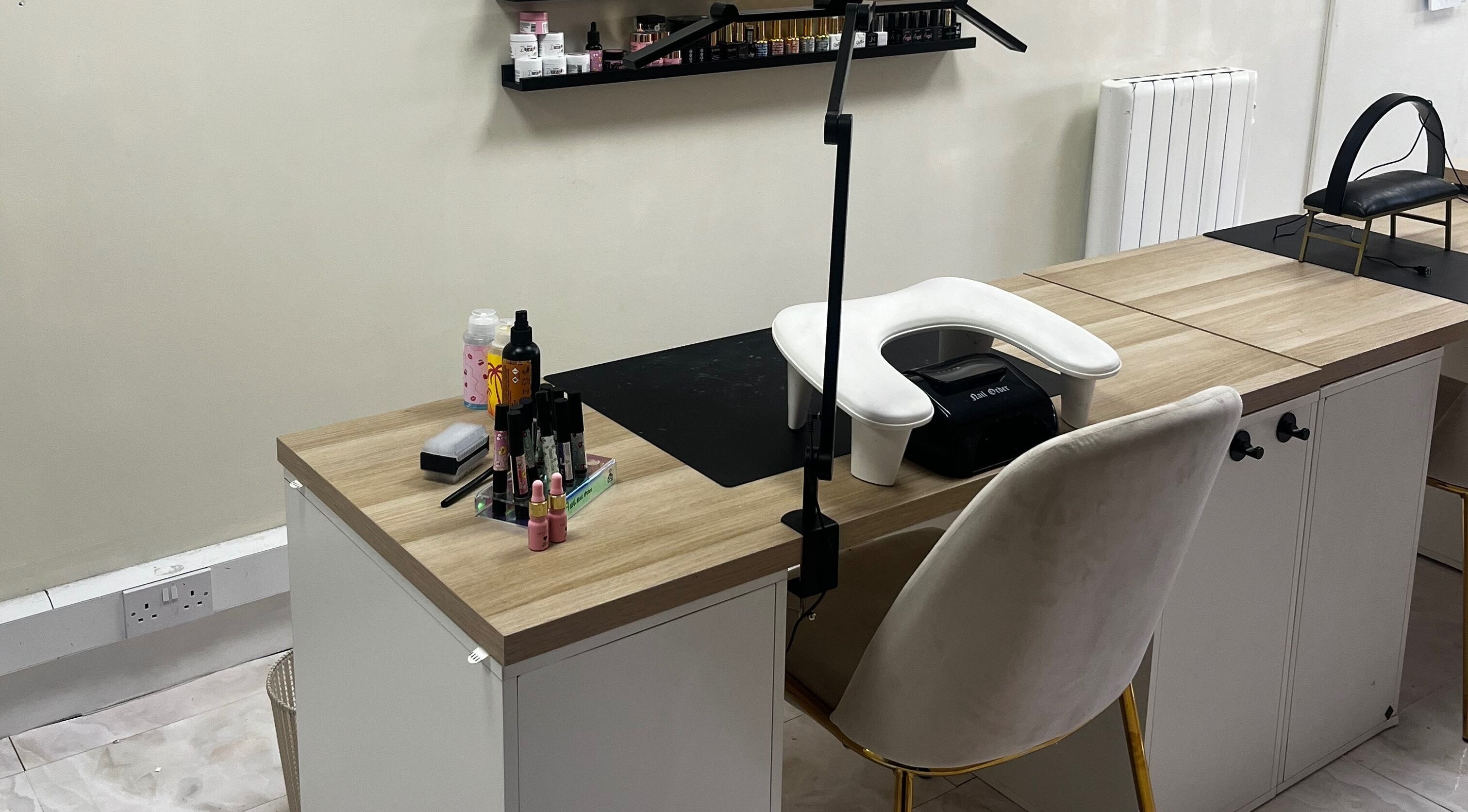 Modern nail studio at By Carly, Wolverhampton, England, GB with manicure tools on a chic wooden table.