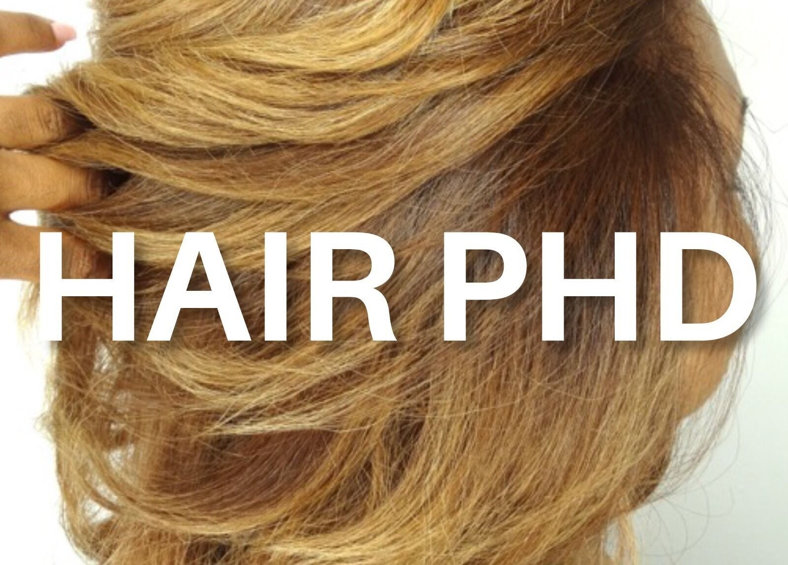 Client showcasing vibrant blonde hairstyle at HAIR PHD in Toronto, Ontario, CA.