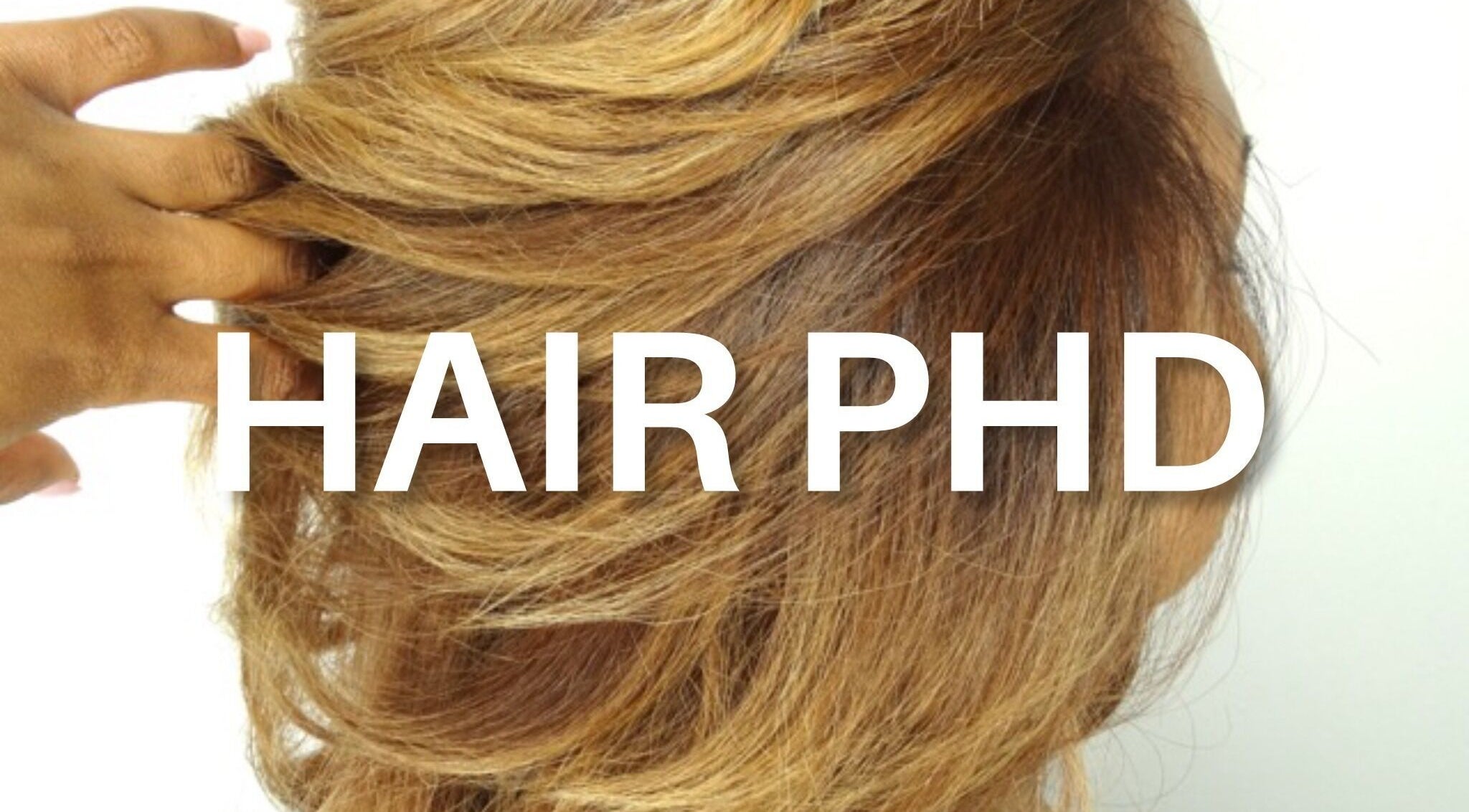 Client showcasing vibrant blonde hairstyle at HAIR PHD in Toronto, Ontario, CA.