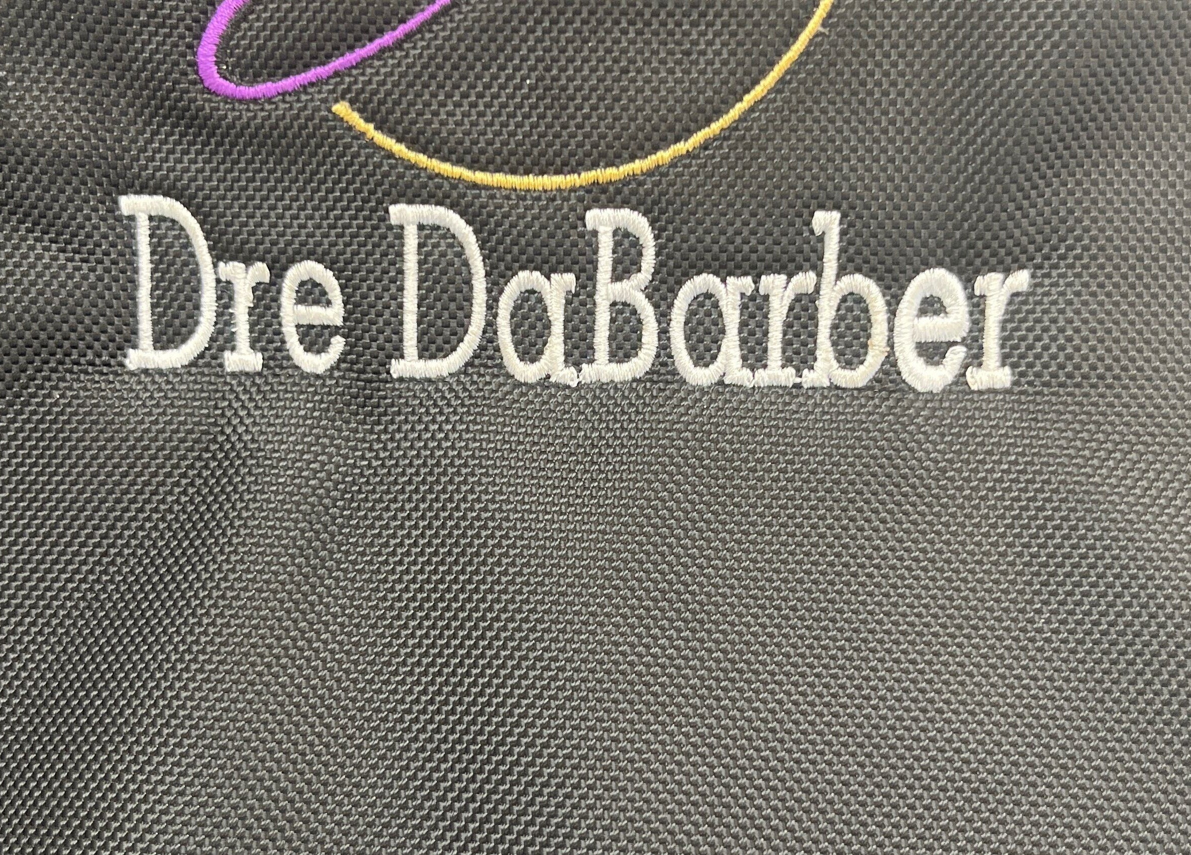 Close-up of embroidered 'Dre DaBarber' on fabric at Elite Kutz and Stylz LLC, Tupelo, Mississippi, US.