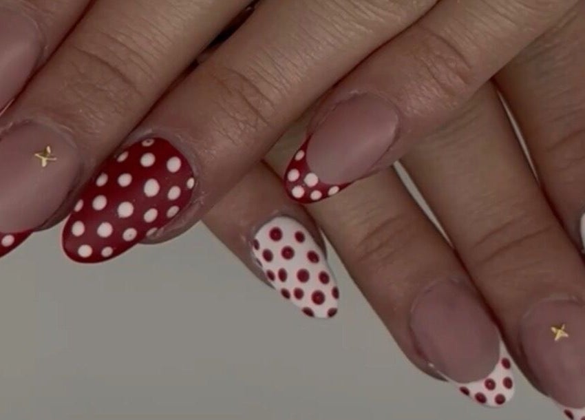 Red and white polka dot nails at Nails by Ela in Blainville, Québec, CA. Trendy and stylish nail art design.