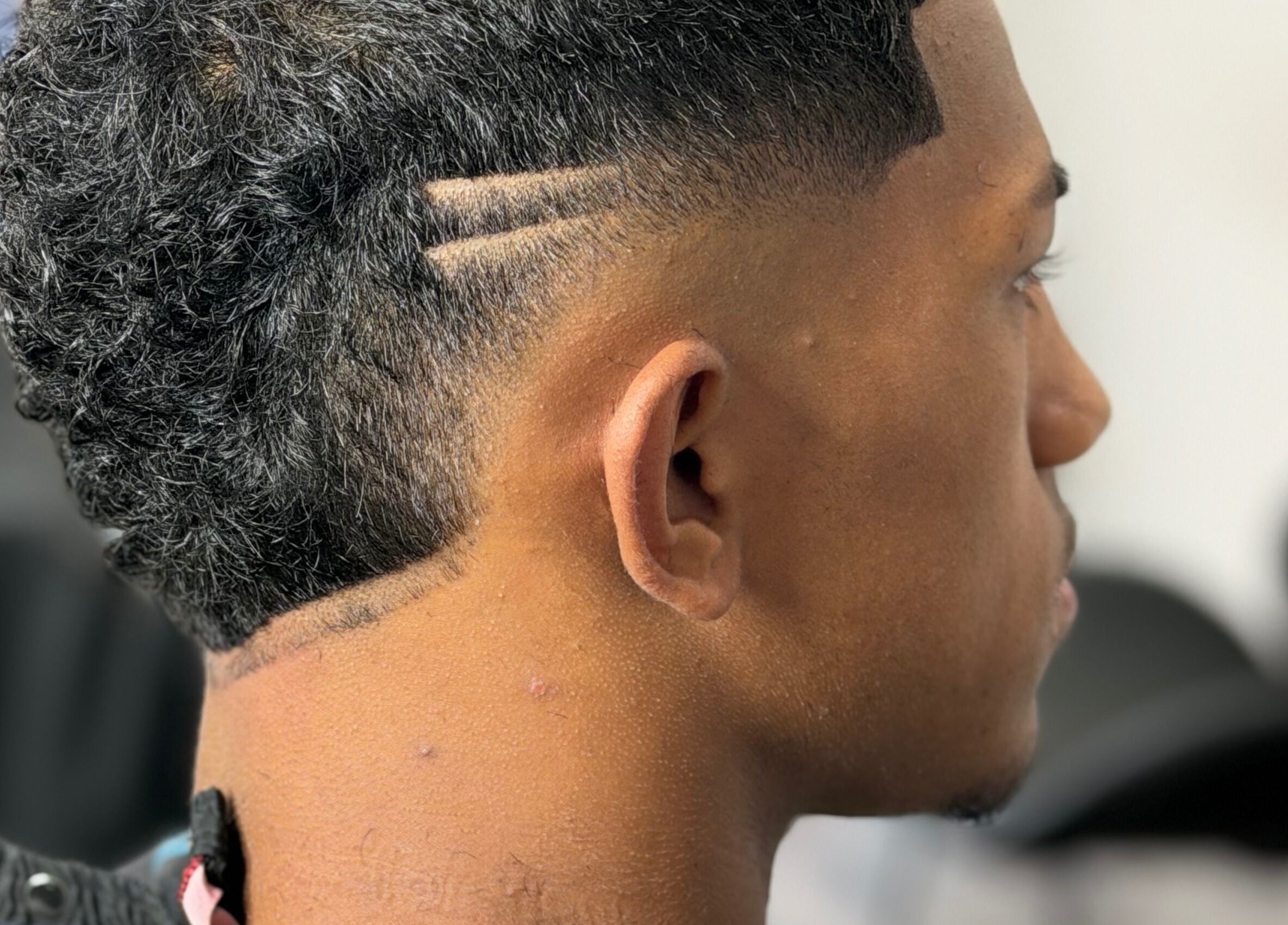 Close-up of modern haircut at JTRIMZ in Guildford West, New South Wales, AU, showcasing precise styling.