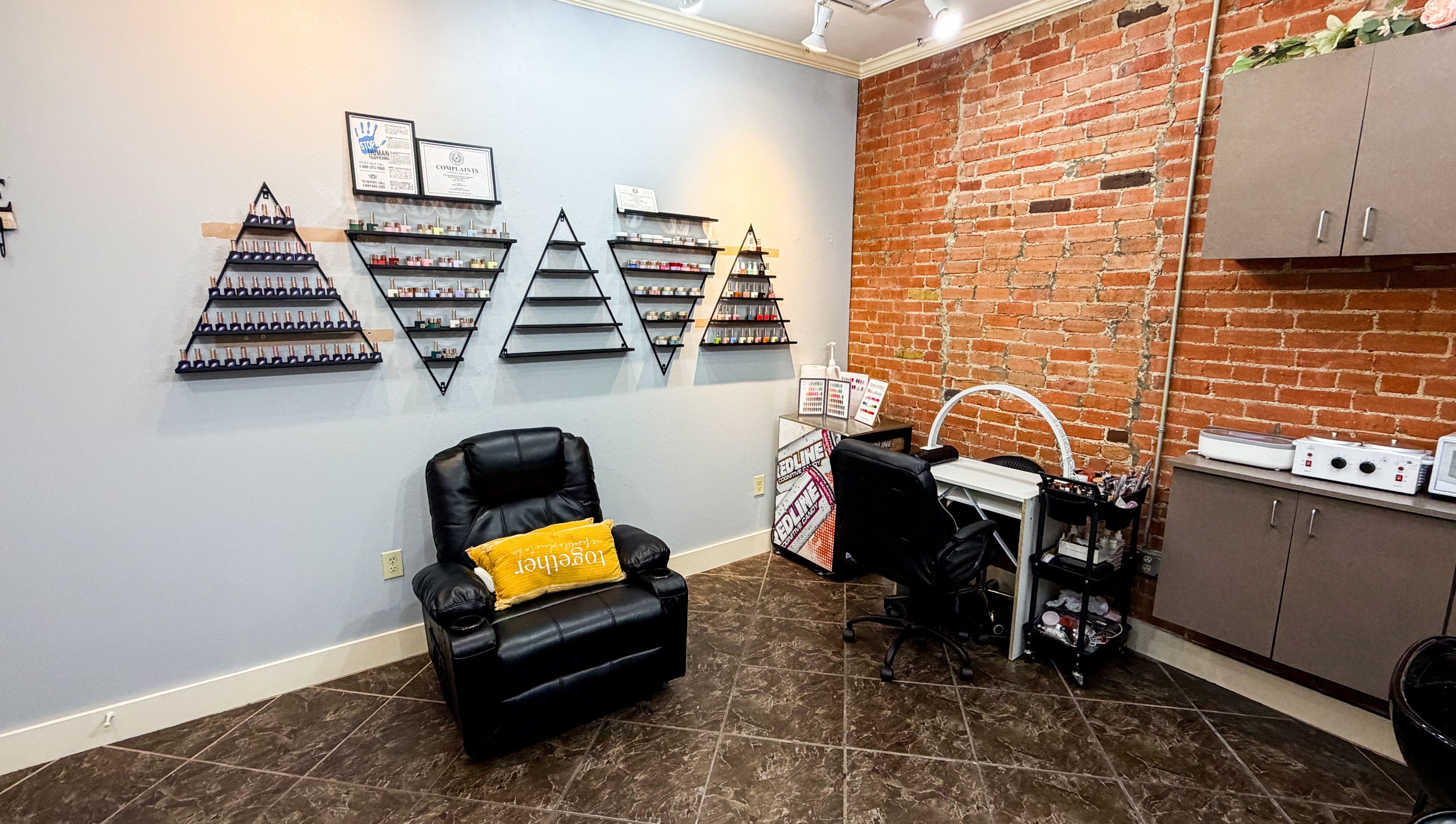 Chic nail treatment area at D Lounge Beauty Spa in Mckinney, Texas, US featuring modern decor and seating.