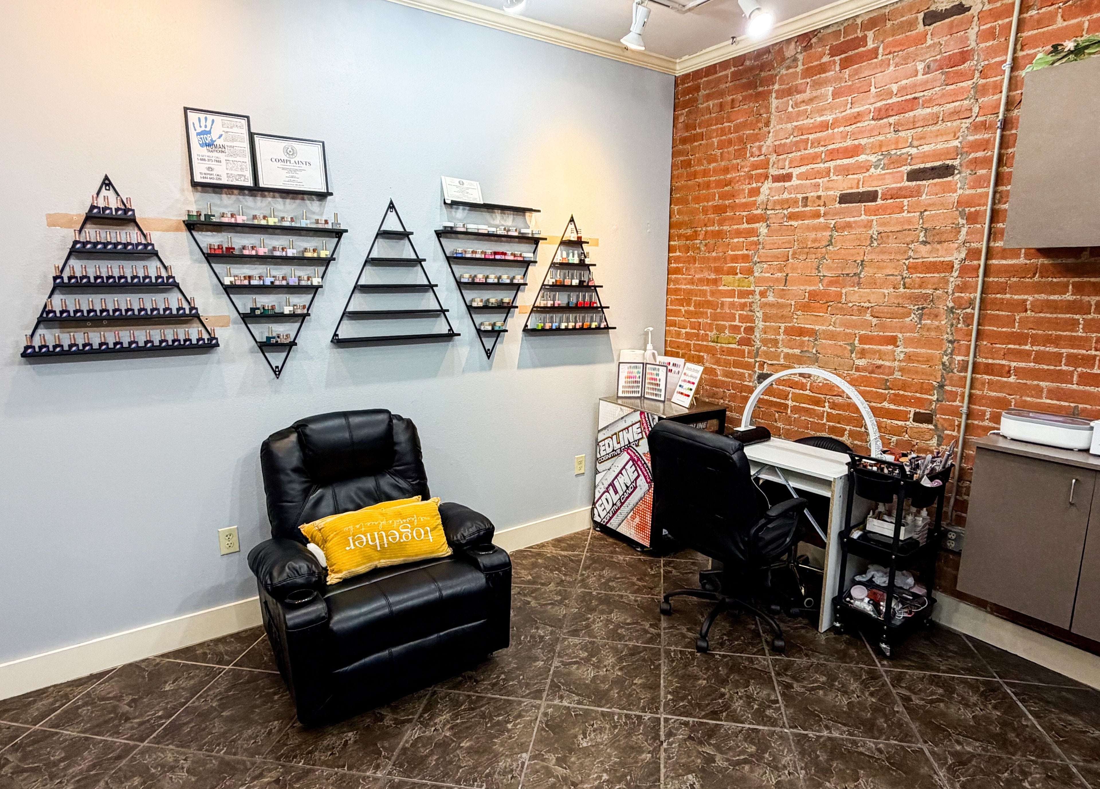 Chic nail treatment area at D Lounge Beauty Spa in Mckinney, Texas, US featuring modern decor and seating.