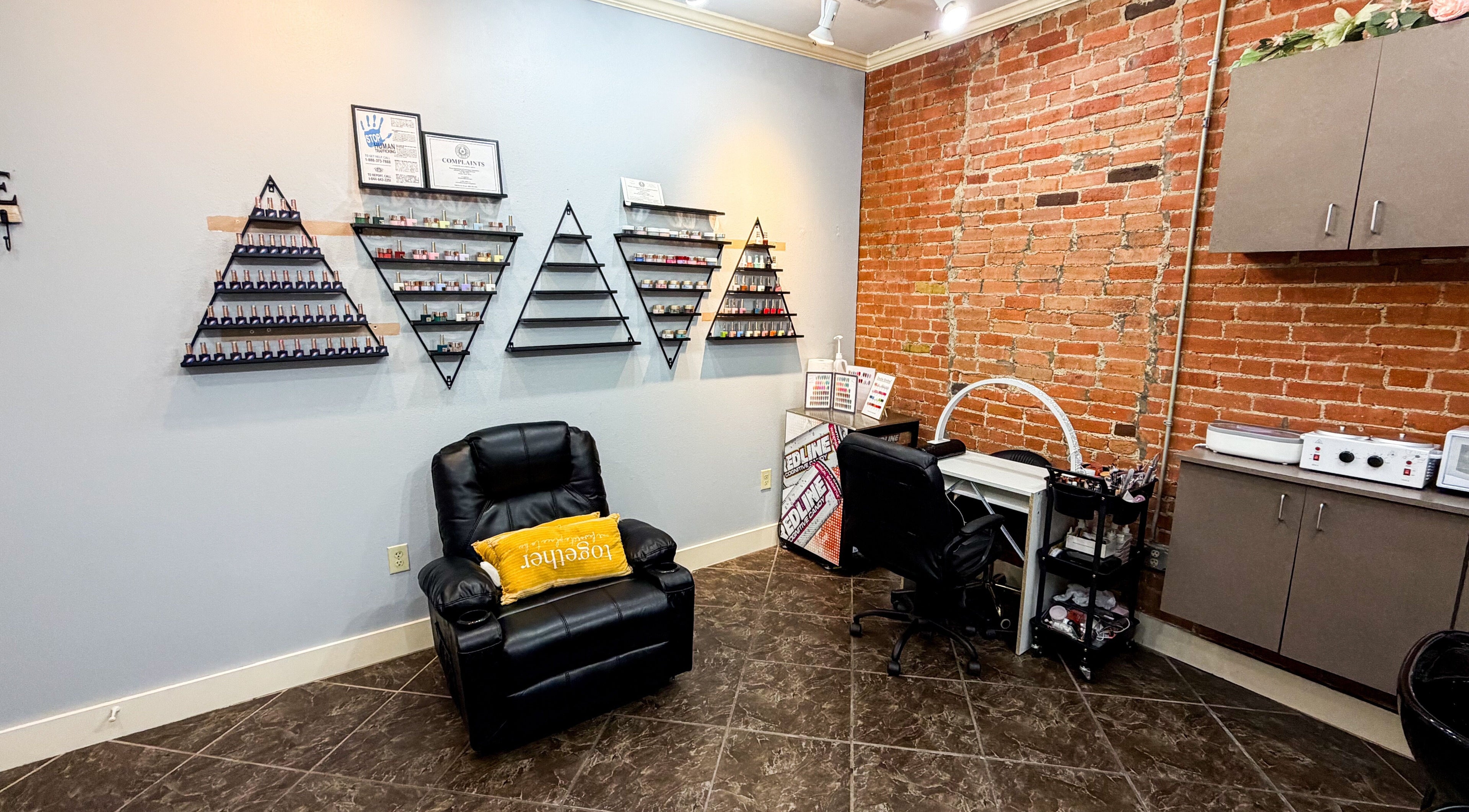Chic nail treatment area at D Lounge Beauty Spa in Mckinney, Texas, US featuring modern decor and seating.