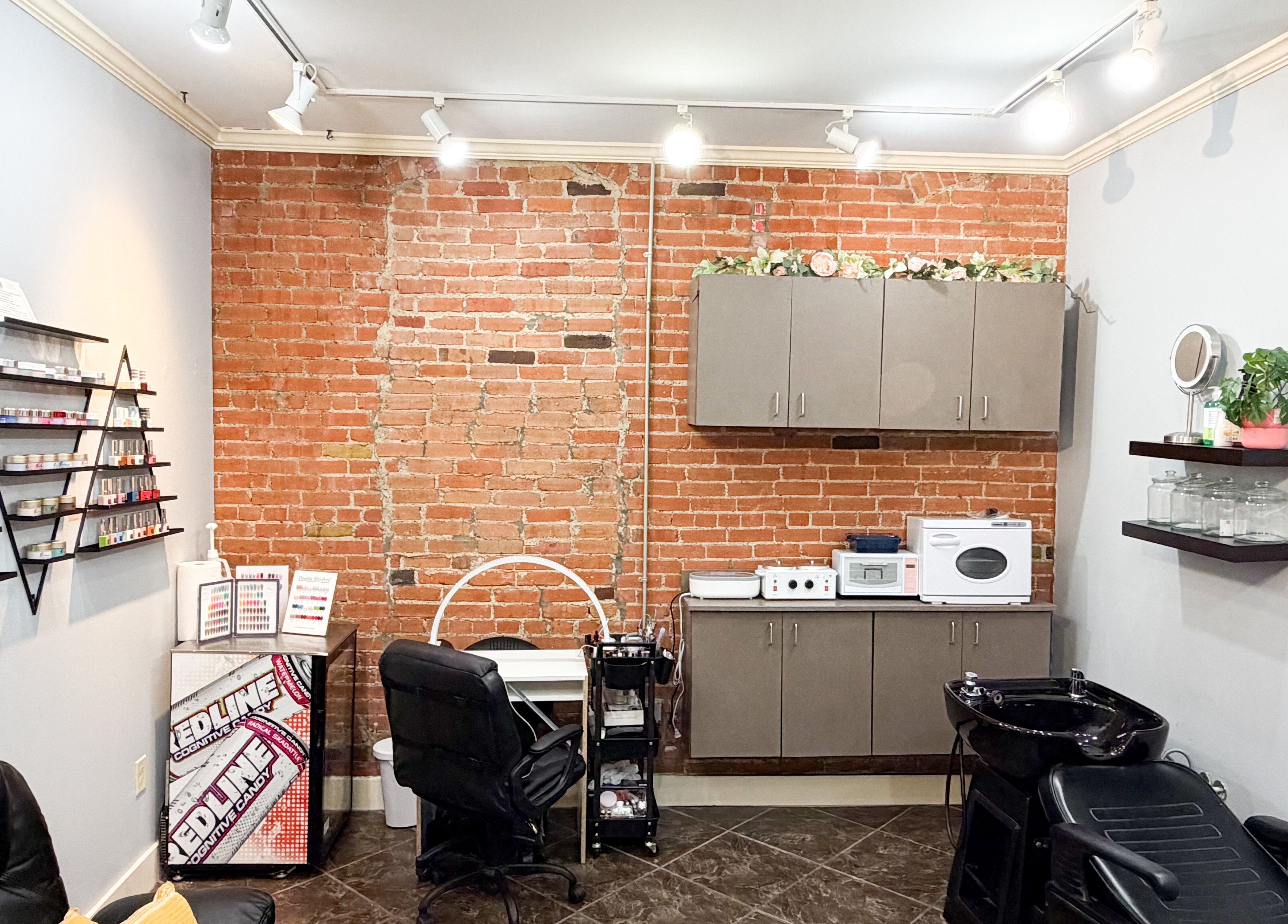 Cozy treatment space at D Lounge Beauty Spa with a brick accent wall, Mckinney, Texas, US.