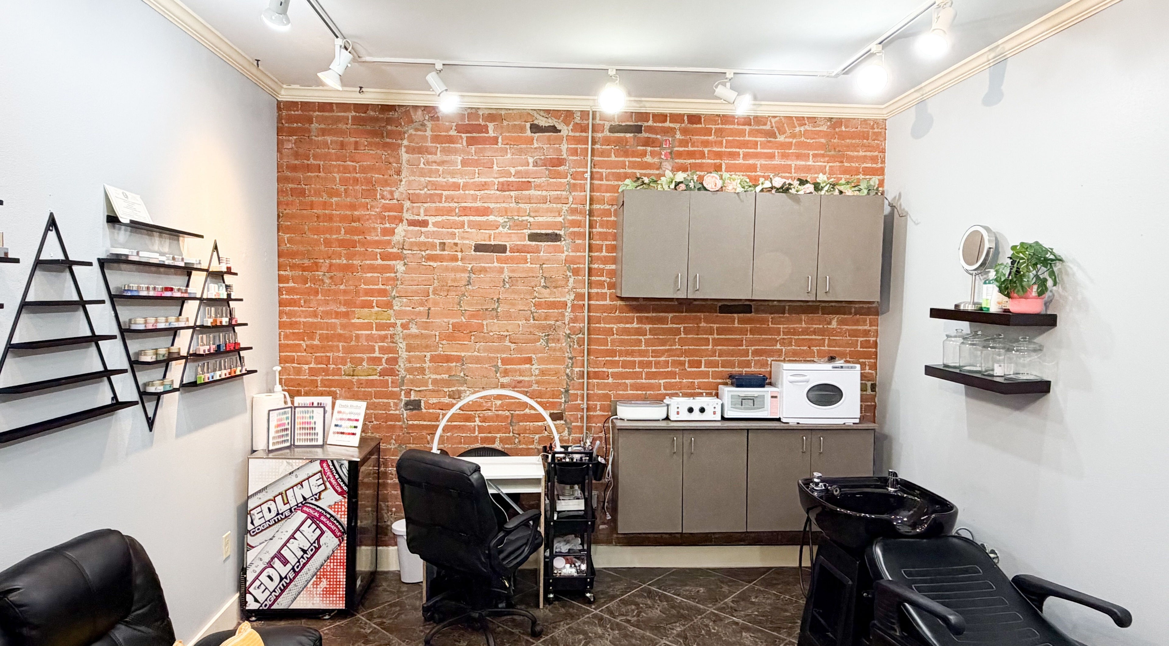 Cozy treatment space at D Lounge Beauty Spa with a brick accent wall, Mckinney, Texas, US.