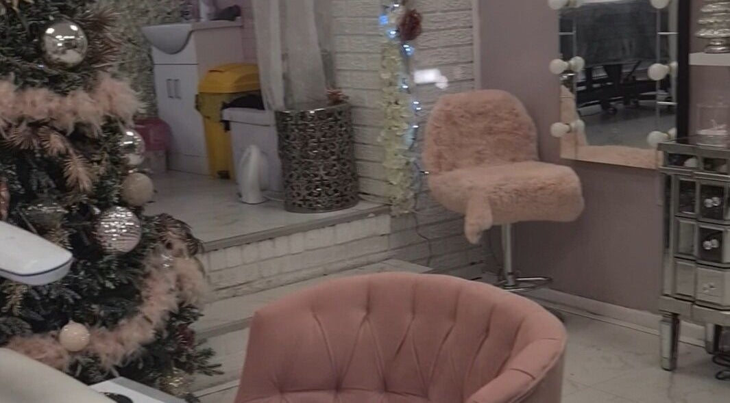 Warm, inviting interior of The Healing Touch, Sunderland, England, GB, with soft chairs and festive decor.