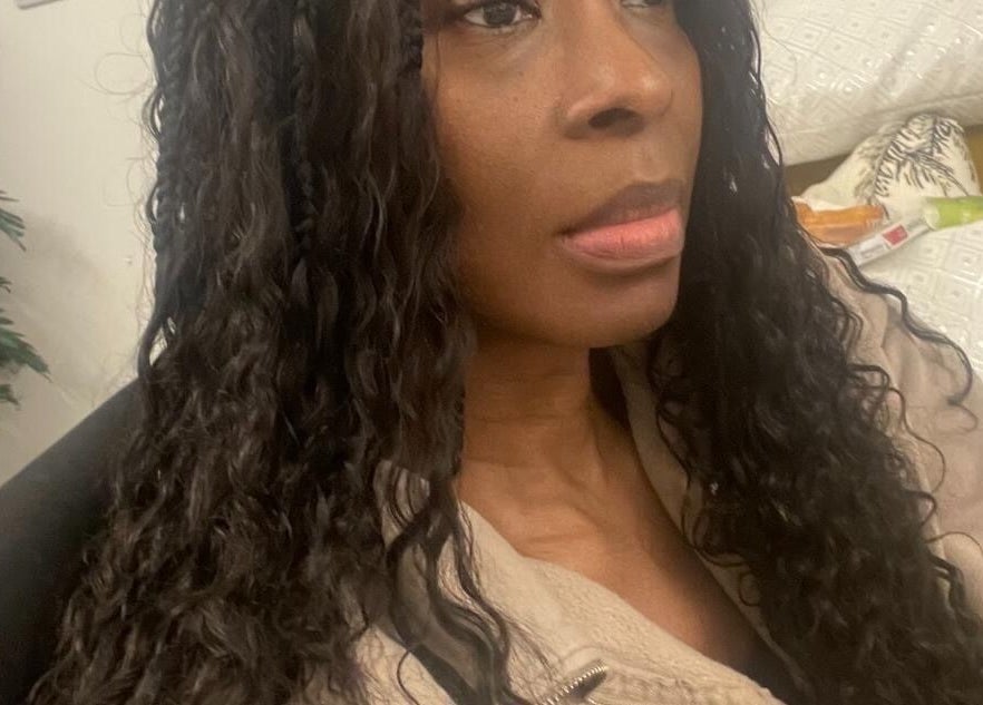 Stylish individual with long curls at Hair & Beauty By Sandyrule, Erith, England, GB.