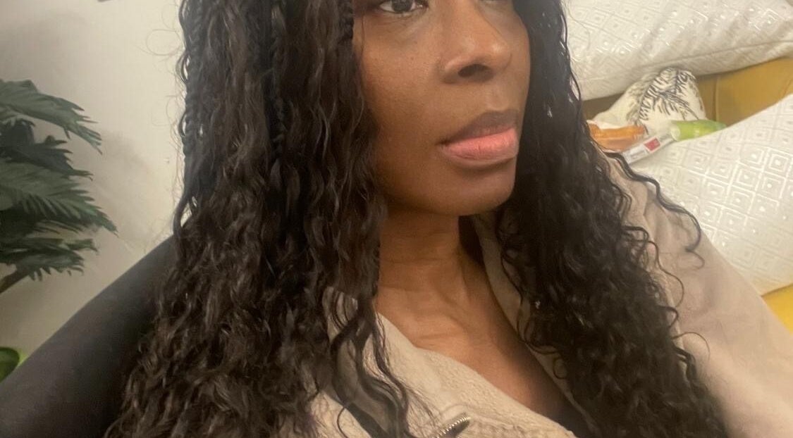 Stylish individual with long curls at Hair & Beauty By Sandyrule, Erith, England, GB.