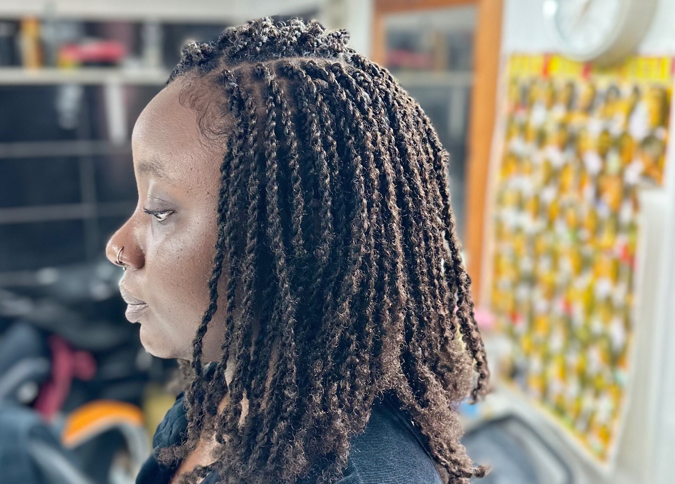 Side view of braided hairstyle at Hair & Beauty By Sandyrule, Erith, England, GB showcasing intricate twists.