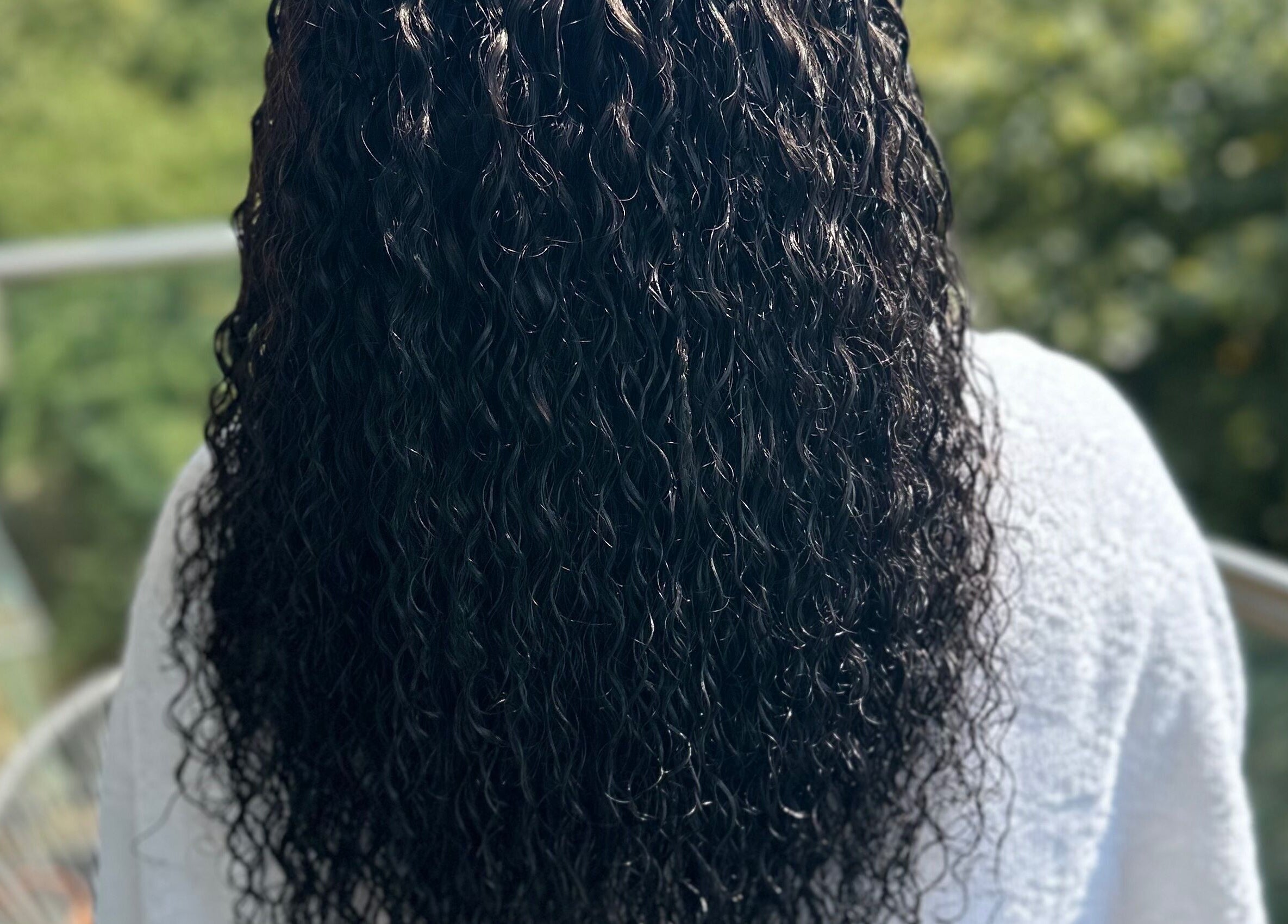 Lustrous curly hair at Hair & Beauty By Sandyrule, Erith, England, GB, showcasing expert styling.