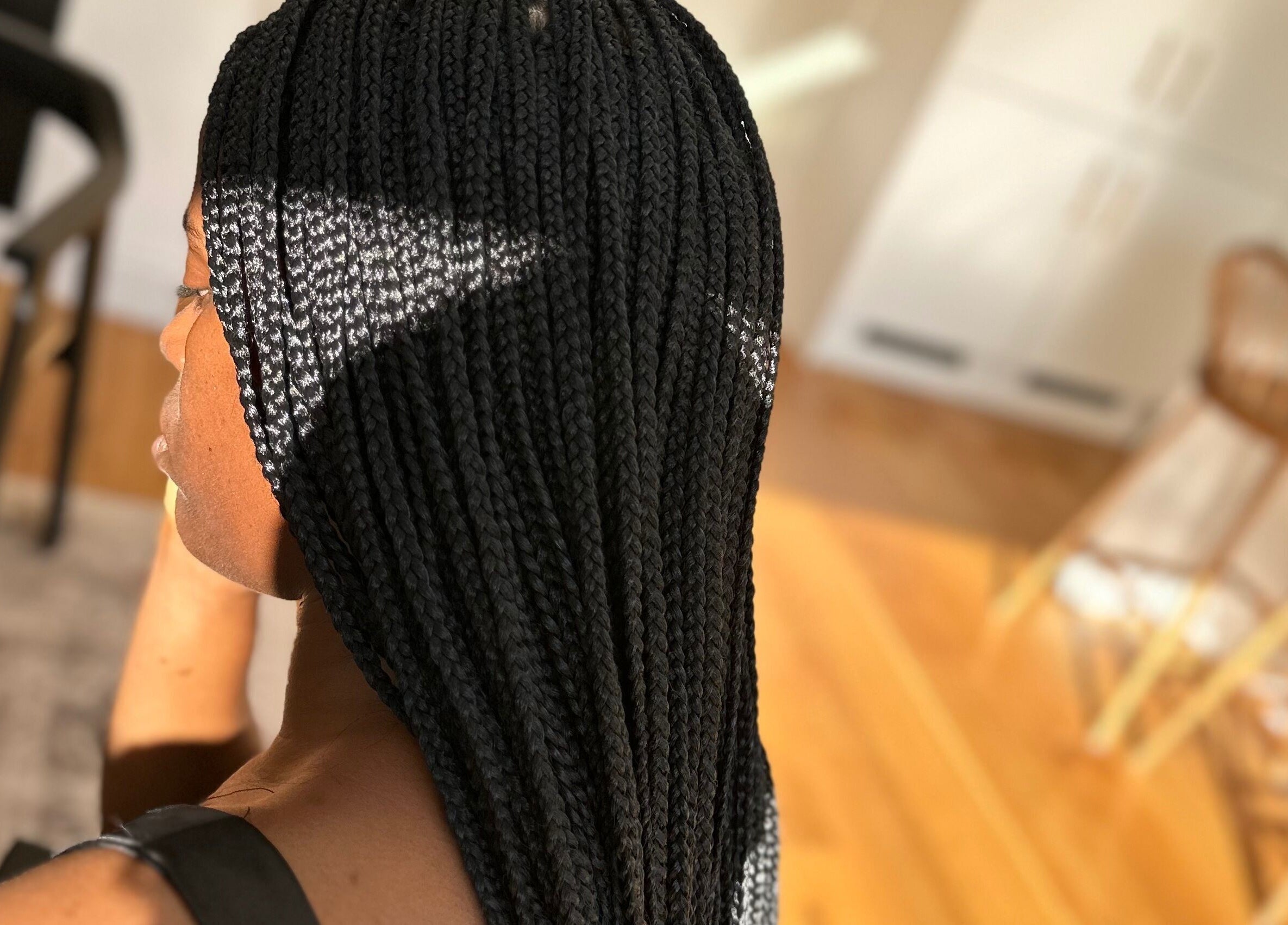 Woman with stylish braids at Hair & Beauty By Sandyrule, Erith, England, GB.