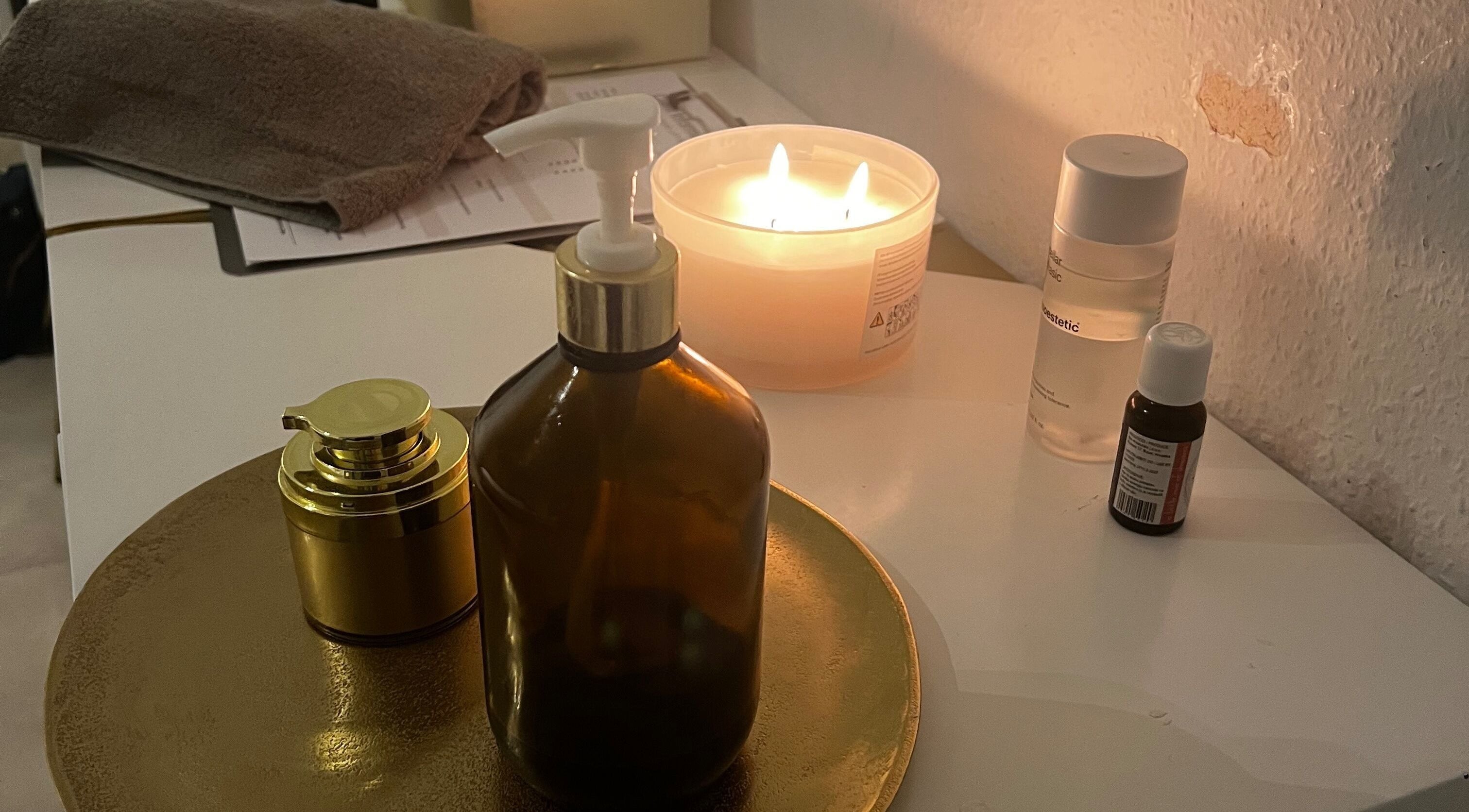 Cozy candle-lit spa ambiance at AERA VIII, Weil Am Rhein, Baden-Württemberg, DE, with elegant beauty products.