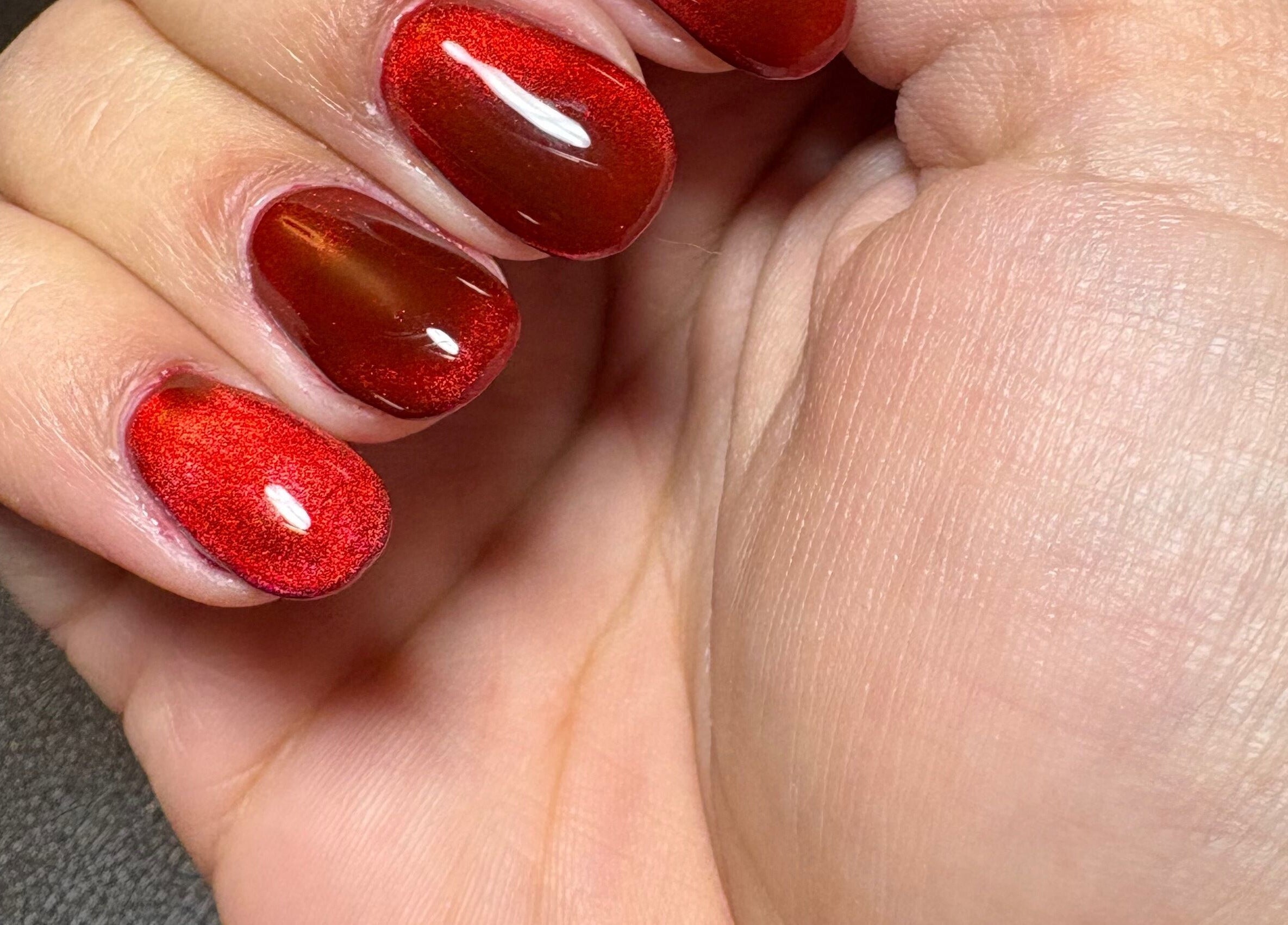Close-up of vibrant red nails at Kei Luxe Nails, Oxford, Massachusetts, US.