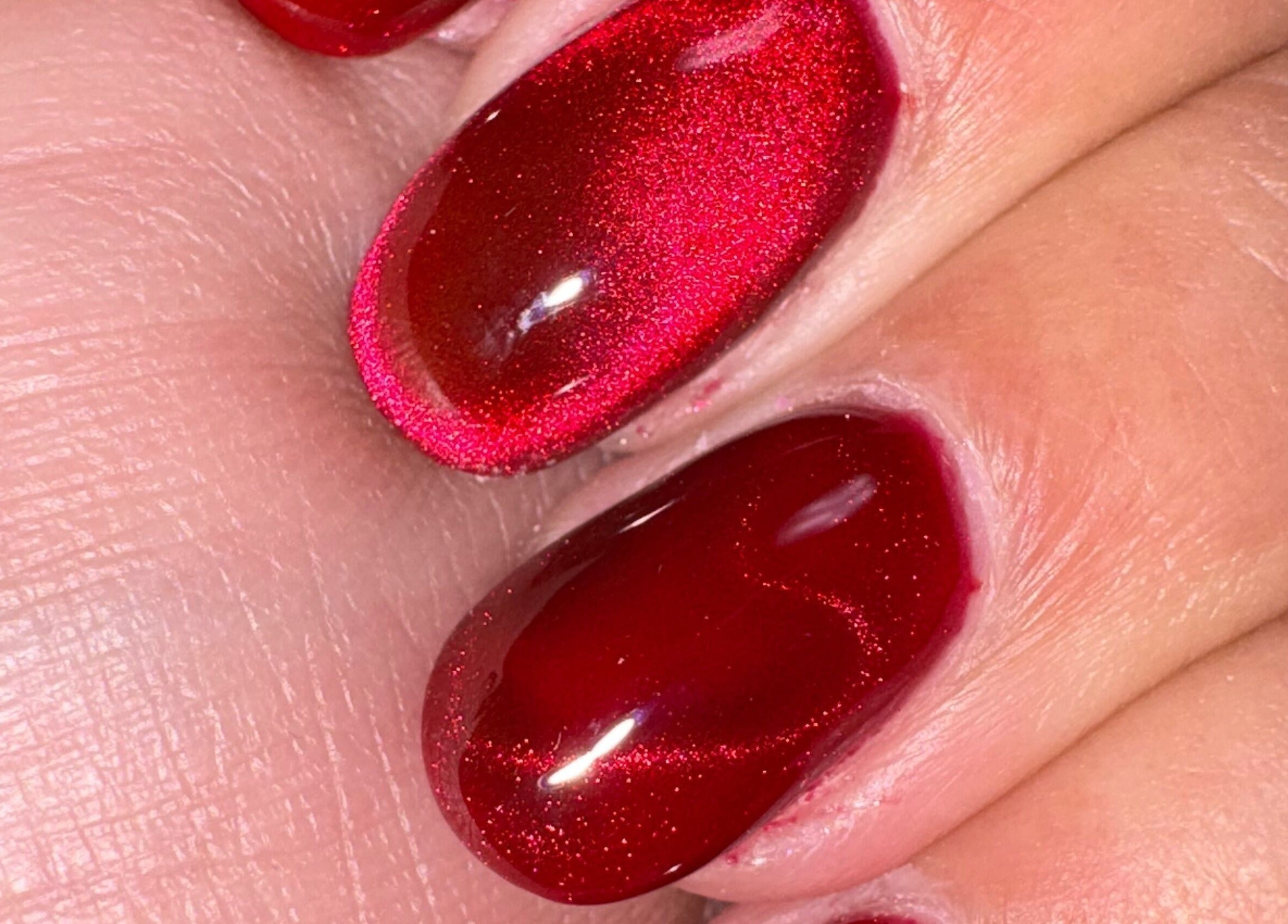 Close-up of vibrant red nails from Kei Luxe Nails in Oxford, Massachusetts, US showcasing glossy finish.