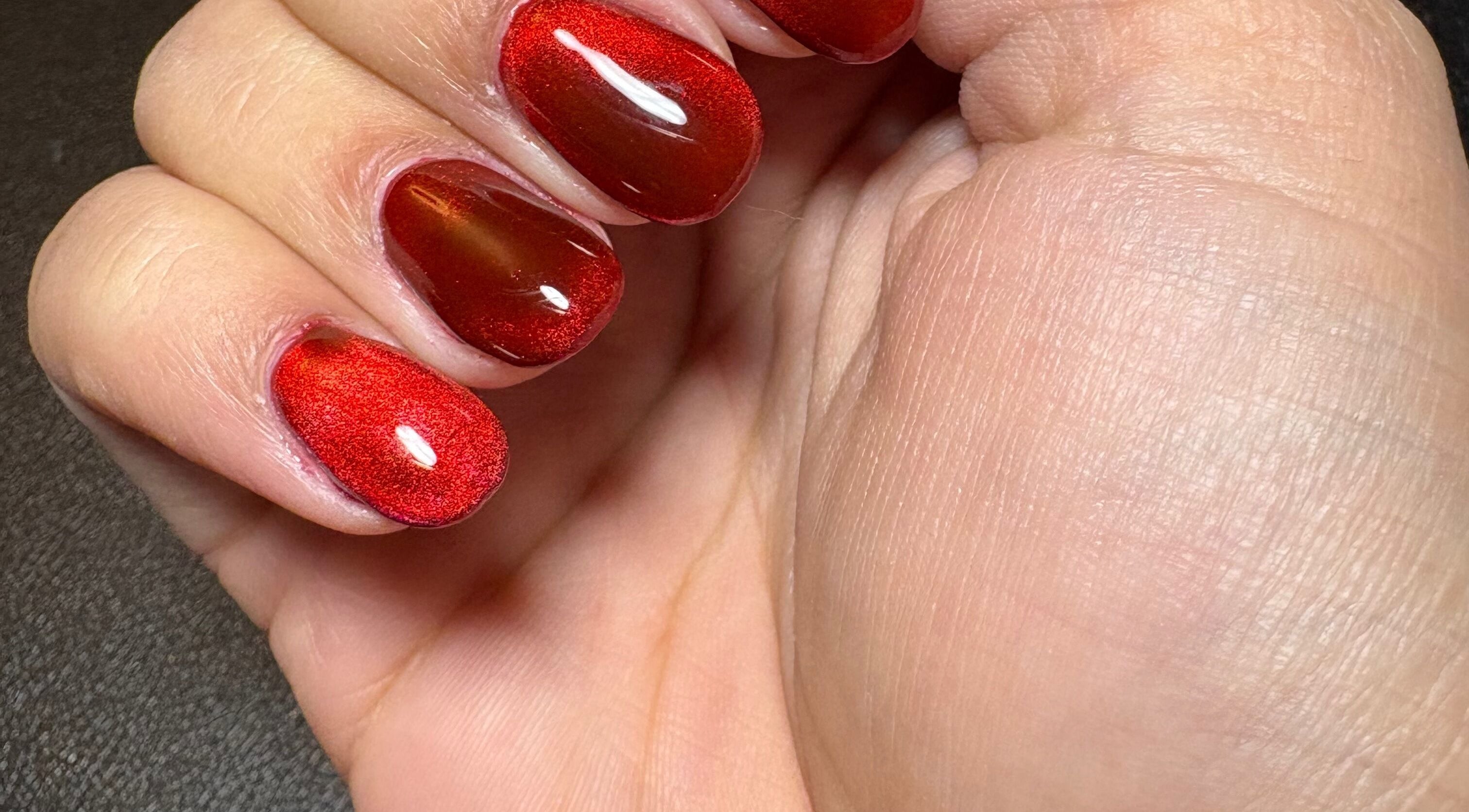 Stunning red manicure at Kei Luxe Nails, Oxford, Massachusetts, US. Perfect for any occasion.