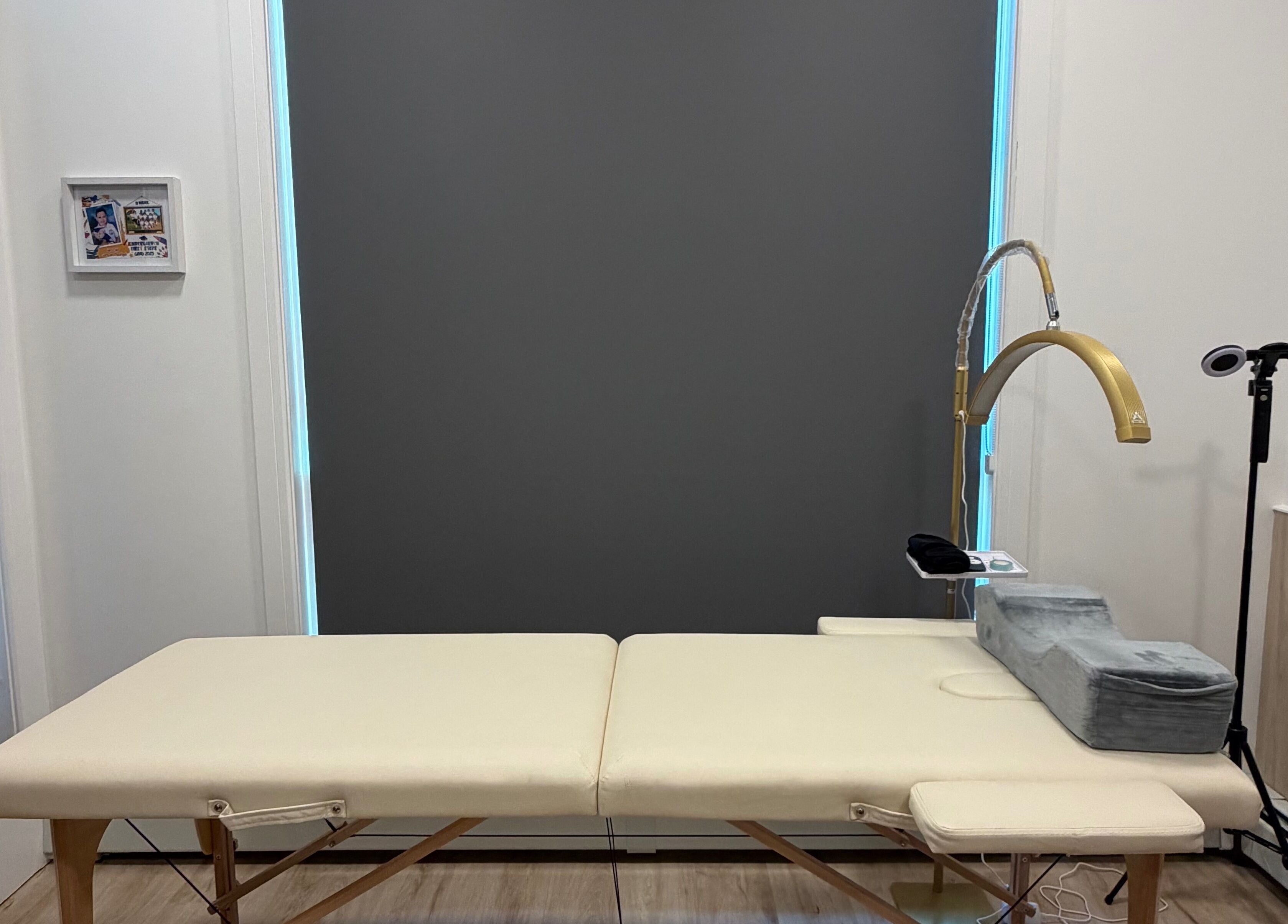 A tranquil treatment room at LASH VIBES, Calgary, Alberta, CA with a plush therapy bed and modern equipment.