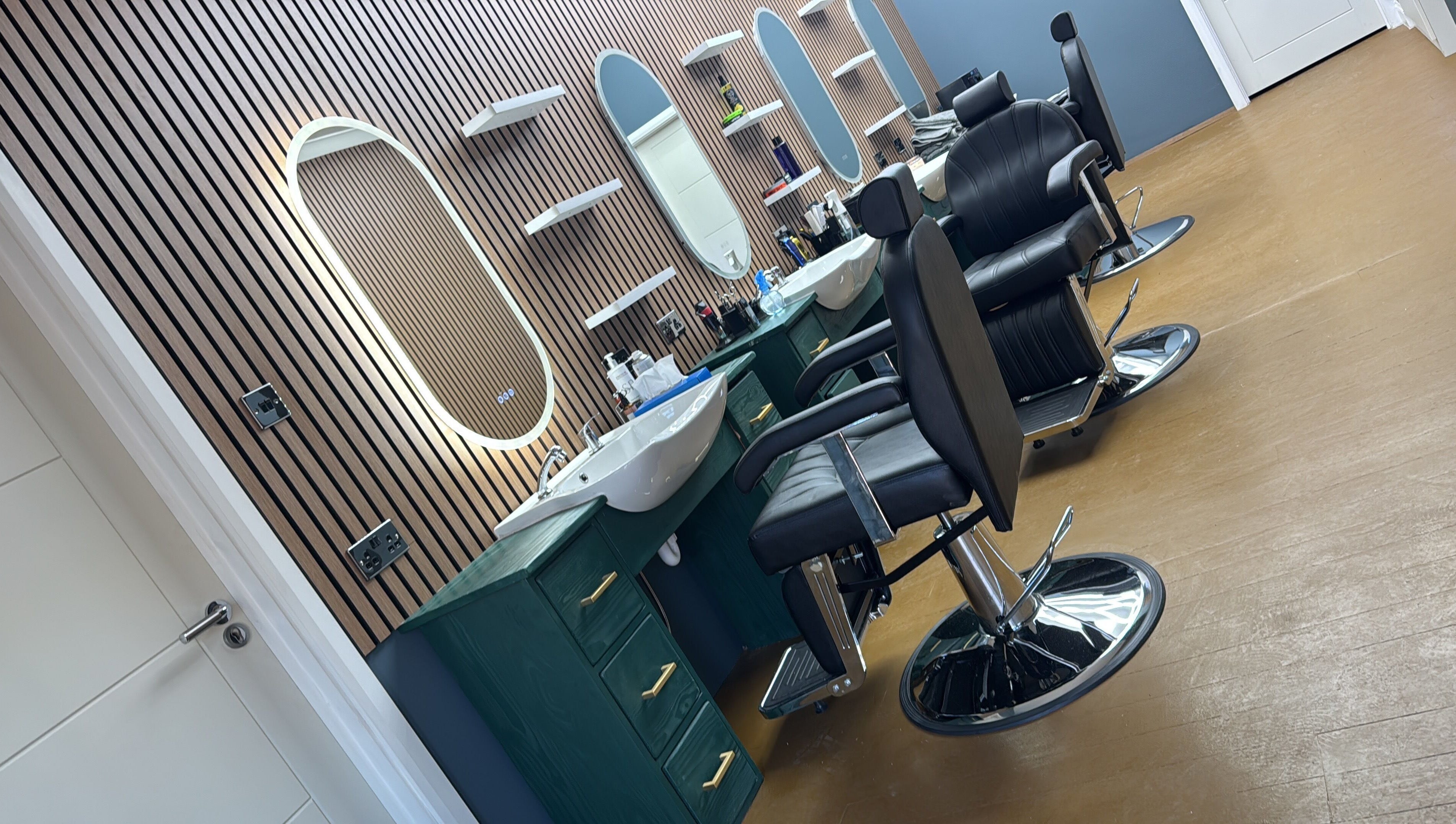 Modern barber chairs and mirrors at STEEL BARBERS, a stylish venue in London, England, GB.