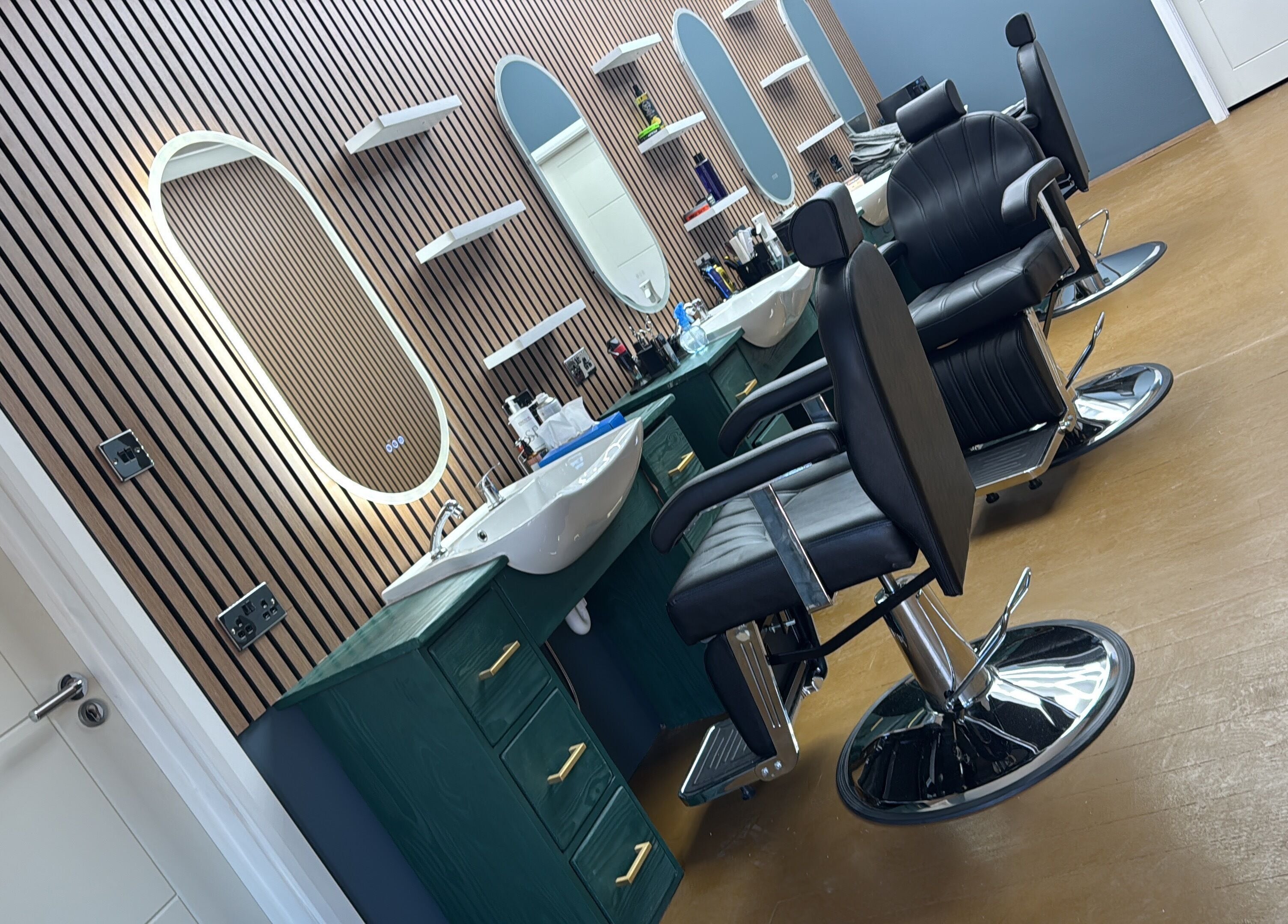 Modern barber chairs and mirrors at STEEL BARBERS, a stylish venue in London, England, GB.