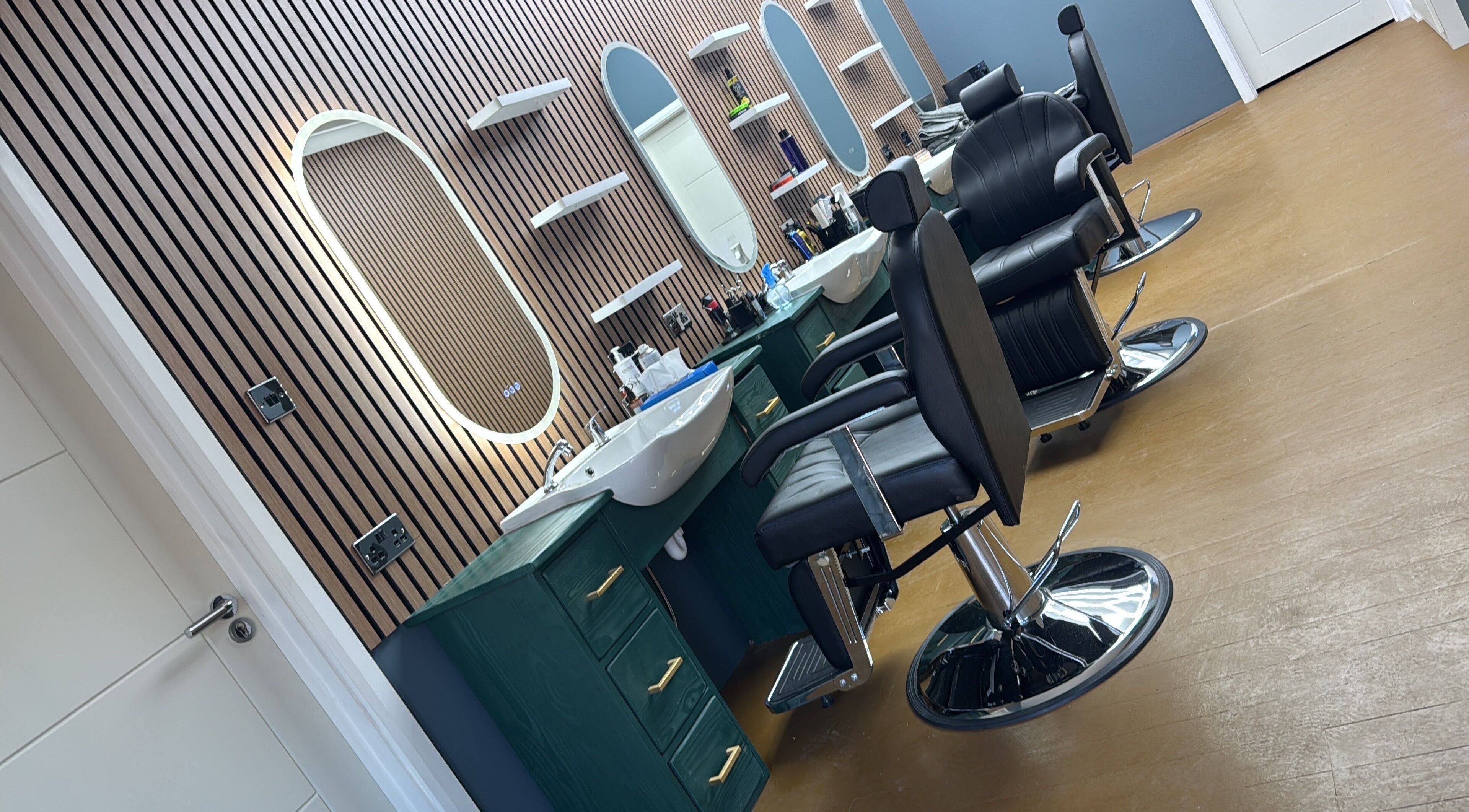 Modern barber chairs and mirrors at STEEL BARBERS, a stylish venue in London, England, GB.