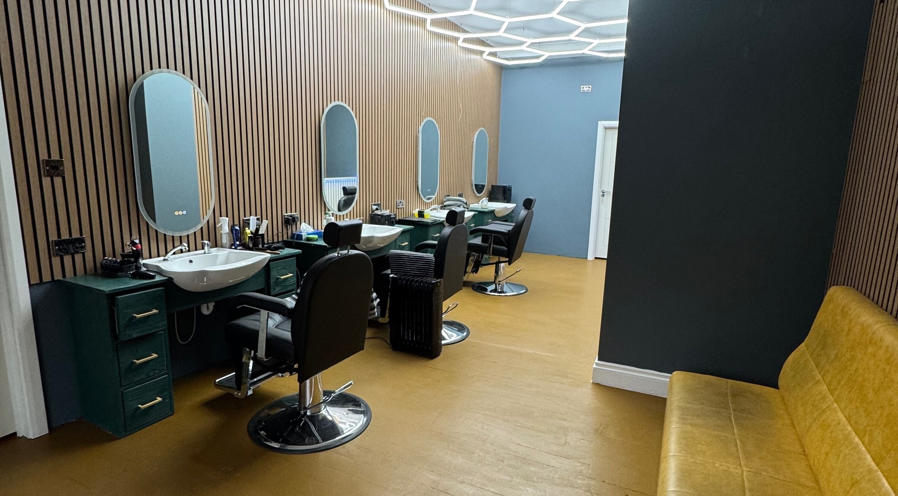 Sleek interior of STEEL BARBERS in London, England, GB showcasing modern barber chairs and mirrors.