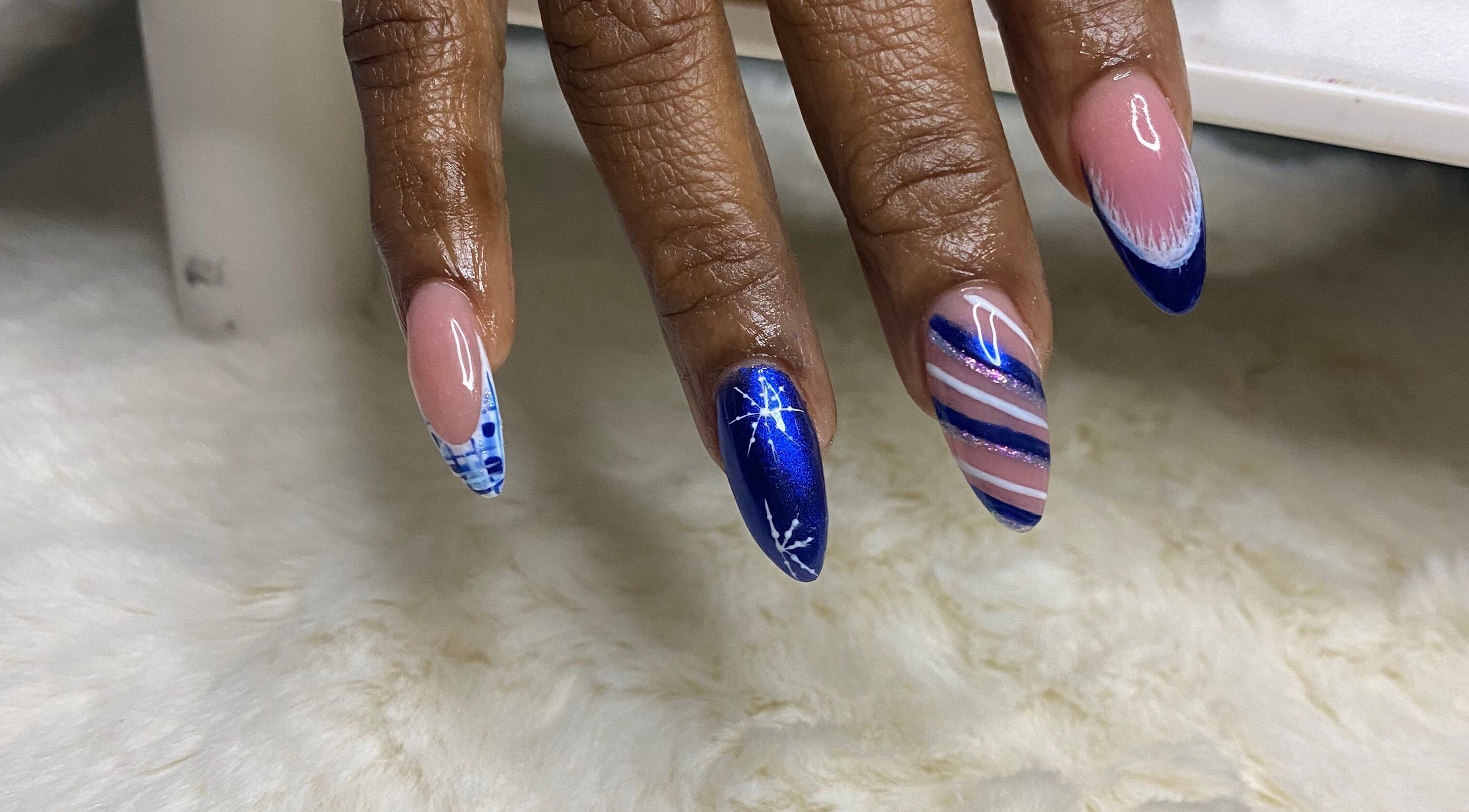 Elegant blue and pink nail art at Red Cutex, Saint George, Saint George, BB, showcasing intricate designs.