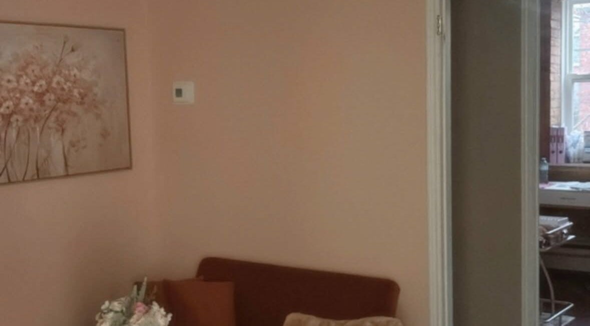 Cozy seating area with floral art at Dyosa Beauty and Wellness Lounge, Hamilton, Ontario, CA.