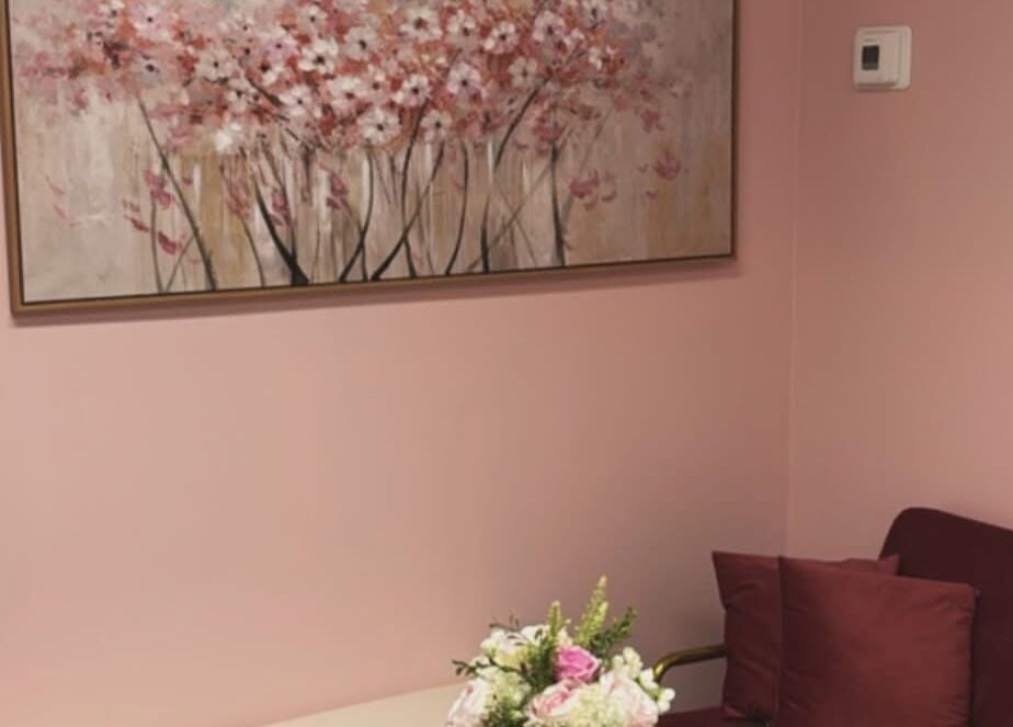 Elegant pink lounge with floral art at Dyosa Beauty and Wellness Lounge, Hamilton, Ontario, CA.
